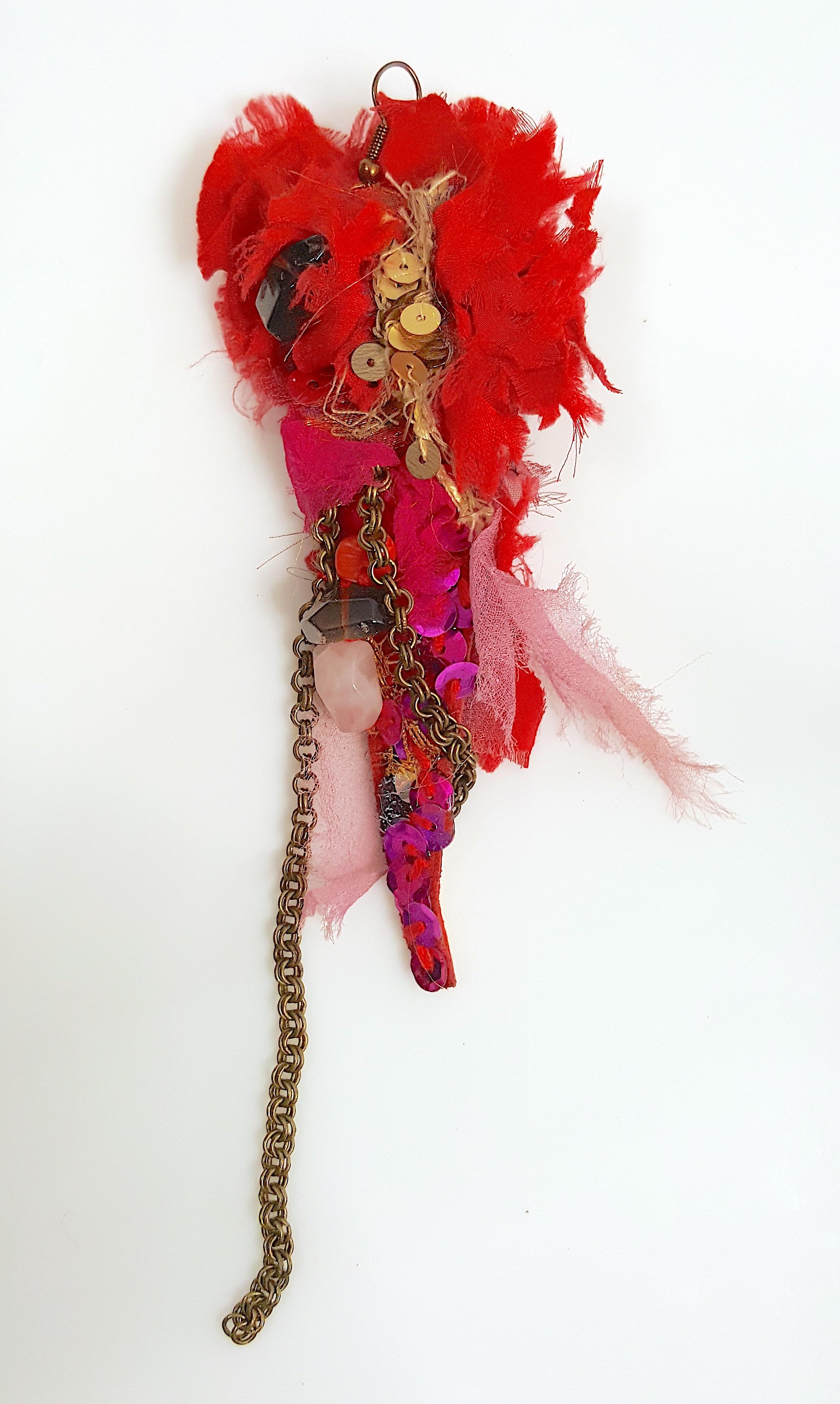 A Parisian haute-couture runway accessory designer for French Jean-Paul Gautier handmade this decadent street-culture-inspired wire-hook earring with multiple tumbled semi-precious stones, gilt chain and cord, and multi-color sequins that suggest
