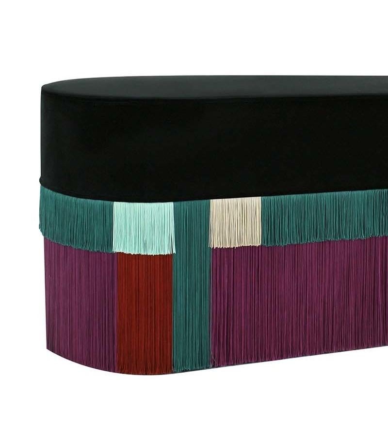 Striking or its vibrant colors, this cotton velvet-upholstered Art Deco-inspired bench adds a sense of movement and sophistication to a refined interior. The continuity of its geometric pattern, bestowed by the handcrafted fringes hanging from the