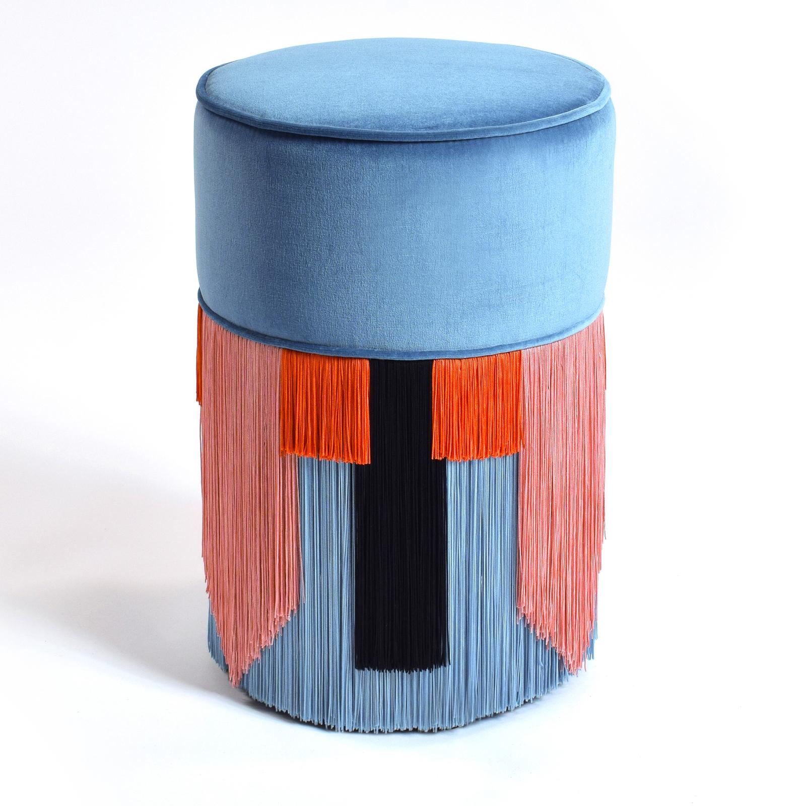 Marked by original design and vibrant colors, the tall and slender beech wood frame of this pouf supports the seat cushion, filled with synthetic padding and upholstered in a delicate light blue velvet for a long-lasting, soft feel. The bottom half