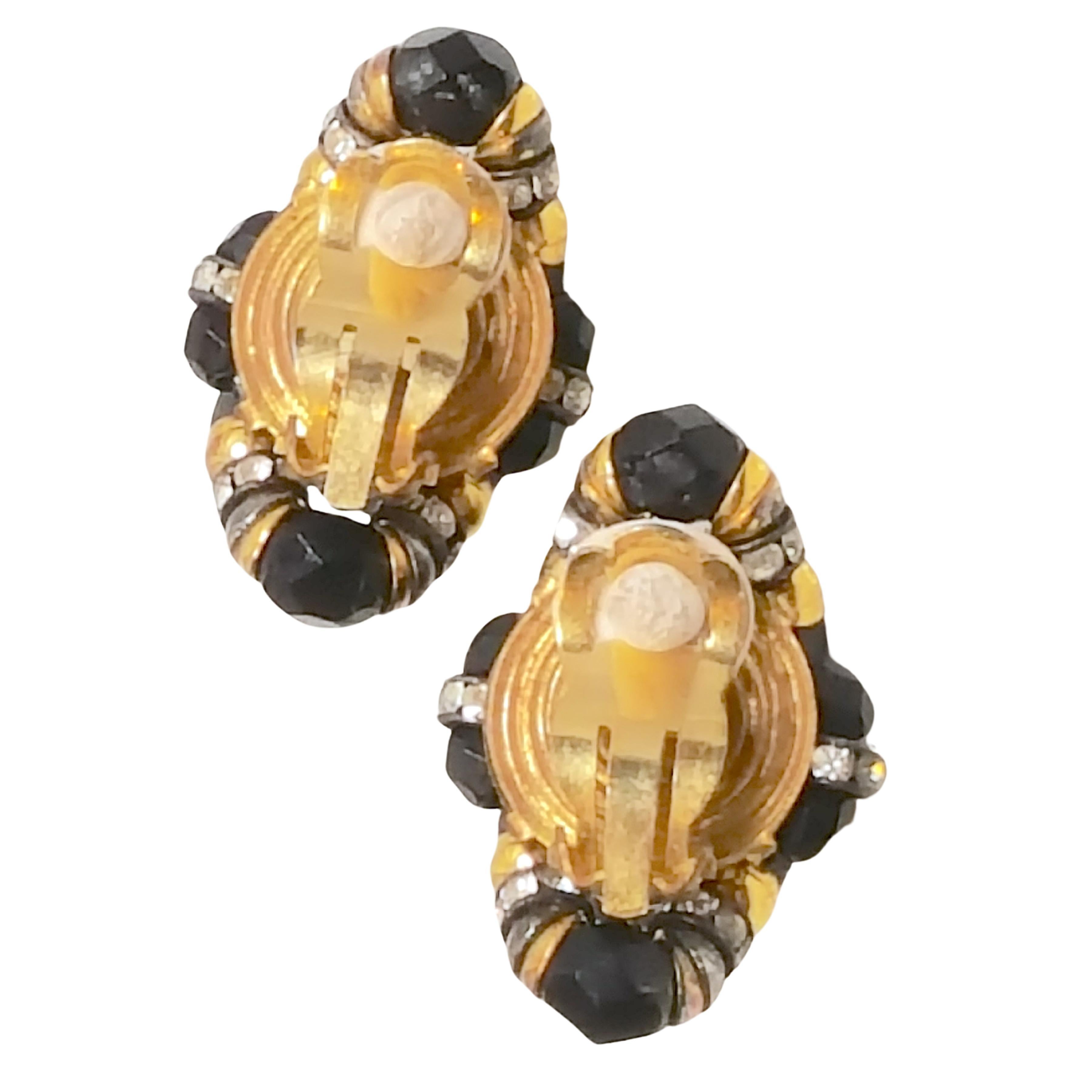 In the 1950s while he operated an eponymous Parisian couture costume-jewelry boutique, Francoise Montague designed these unique handmade ornate pair of sparkly clip earrings featuring black faceted-glass beads, prong-set clear crystals,