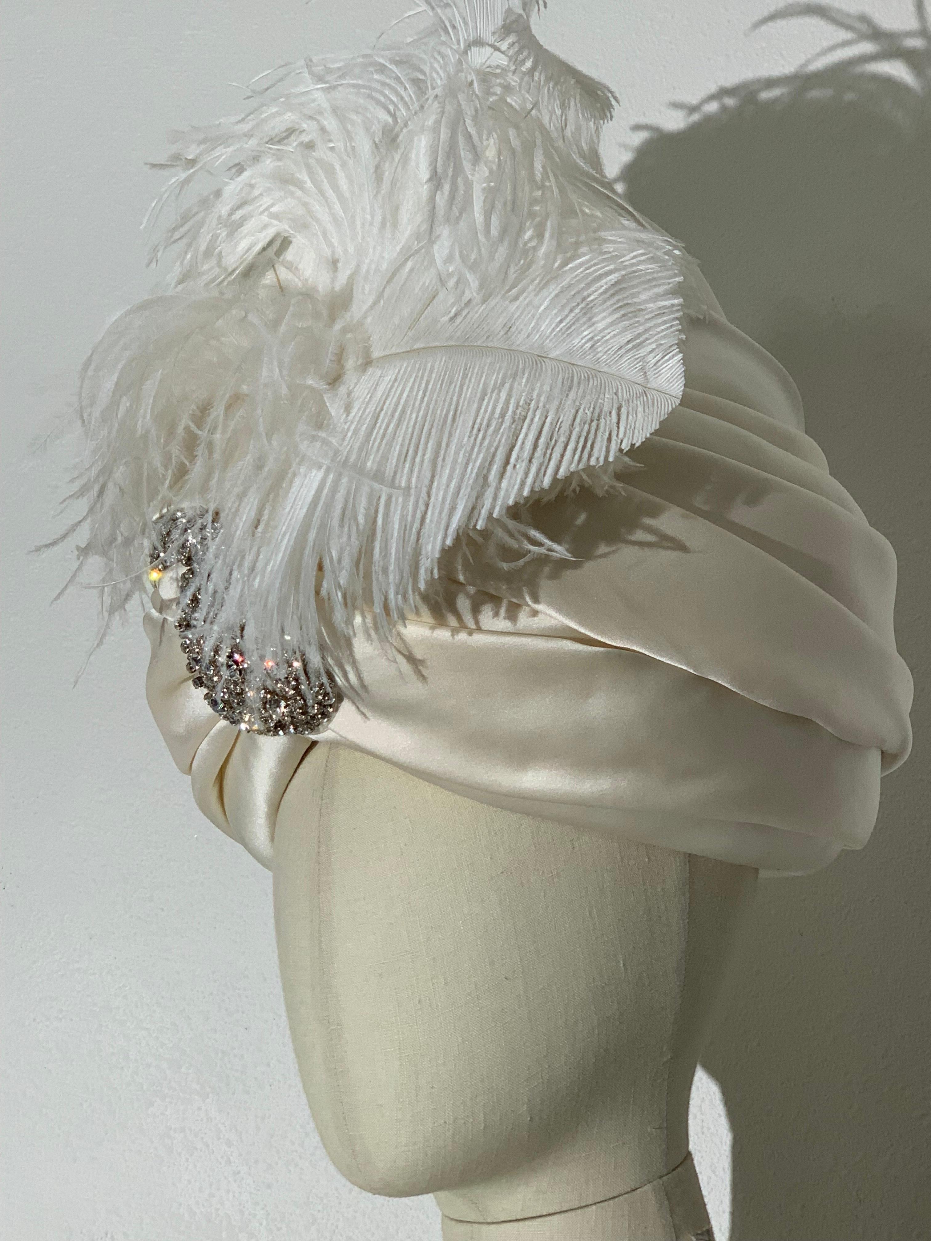 Custom Made White Silk Satin Turban w Incredible Rhinestone Paisley Brooch and White Feathers at Front: Created by Suzanne Couture Millinery. Truly spectacular!  Maharaja worthy! Sumptuous white silk satin in a bold shape, wrapped and draped over a