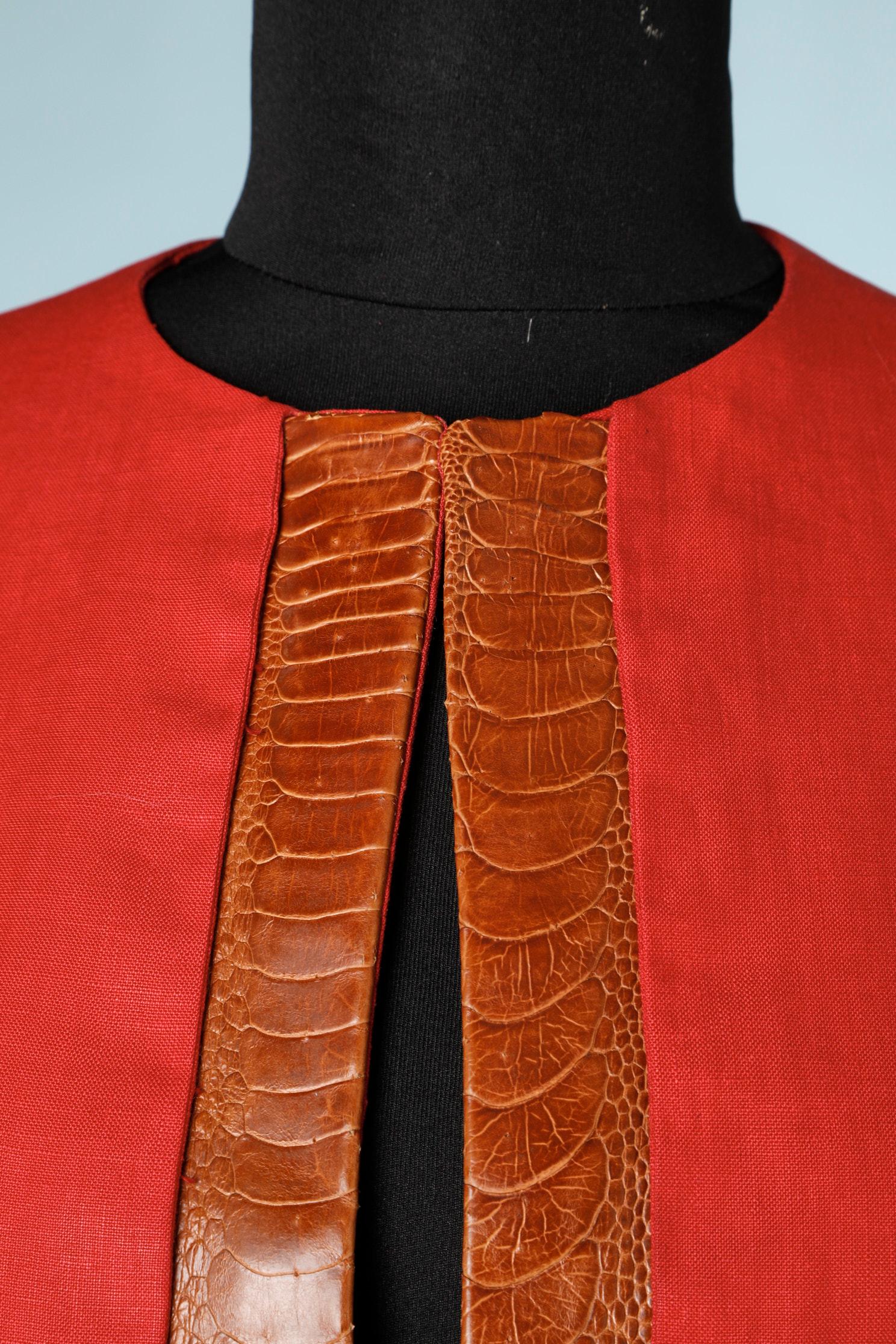Jacket: edge-to-edge red linen jacket with a crocodile skin part on the facing. No button, no lining.
Slight traces of perspiration under the right armpit and slight spot on the right shoulder.

Lecoanet Hemant Couture's House has been created in