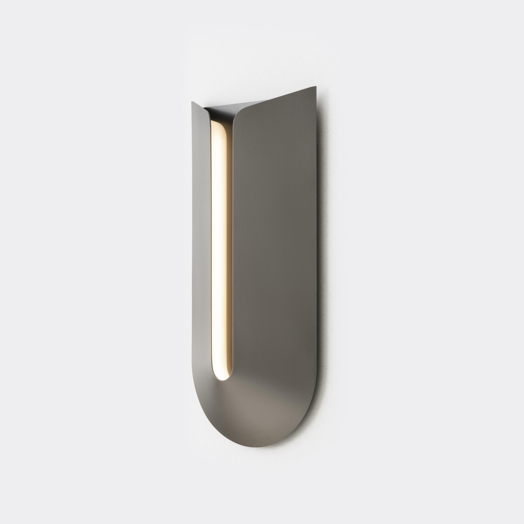 Cove is a low-profile but sizable sconce, with a minimal design that celebrates form and materiality in seemingly endless combinations. Whether mounted to wash light from above or below, the architectural curves of this ADA-compliant piece gently