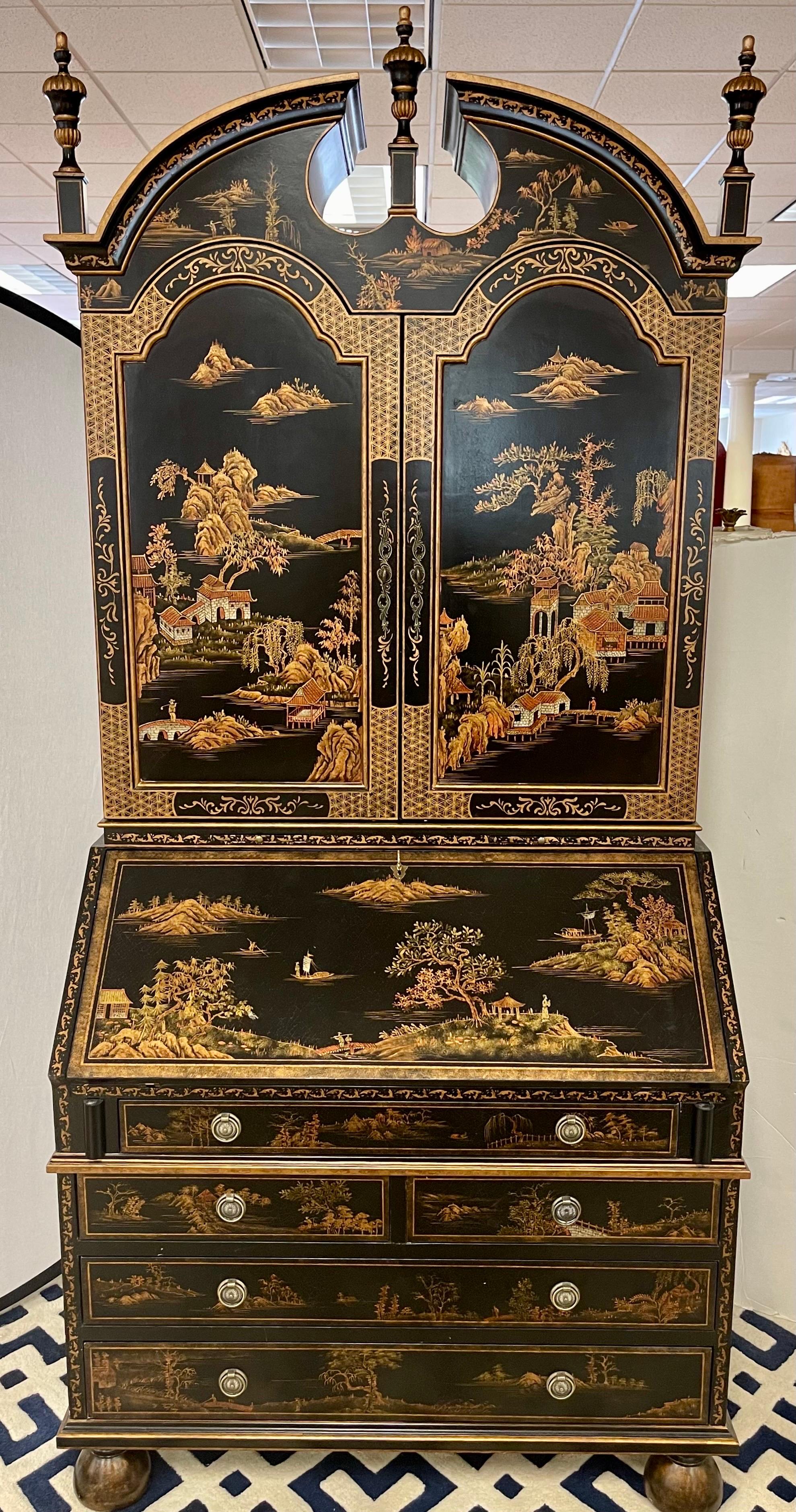 Magnificent Chinoiserie decorated black secretary desk with exquisite hand painted landscape scenery on front and sides. Features 2 pcs with top portion opening to shelves. Bottom has drop leaf desk opening to writing surface with cubbies and