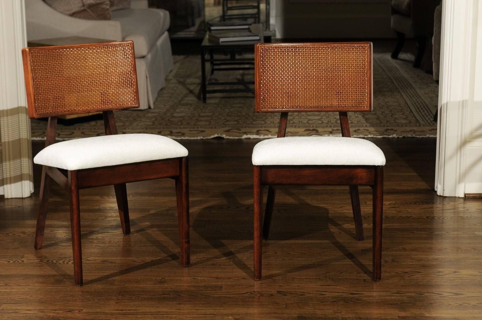 An exquisite set of eight (8) rare cane back dining chairs (Model number 4669) by the esteemed George Nelson for Herman Miller, circa 1949. Single examples of this chair are difficult to locate; a set of this size is the Collector's equivalent of