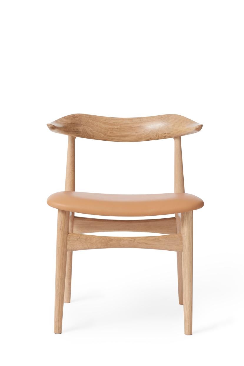 Cow horn chair soavé oak nature leather by Warm Nordic
Dimensions: D55 x W48 x H 74 cm
Material: White oiled solid oak frame, Textile or leather upholstery.
Weight: 7.5 kg
Also available in different colors and finishes. 

The Cow Horn Chair