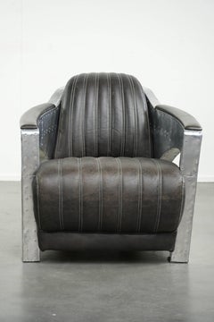 Cow leather aviator design armchair finished with aluminium and rivets