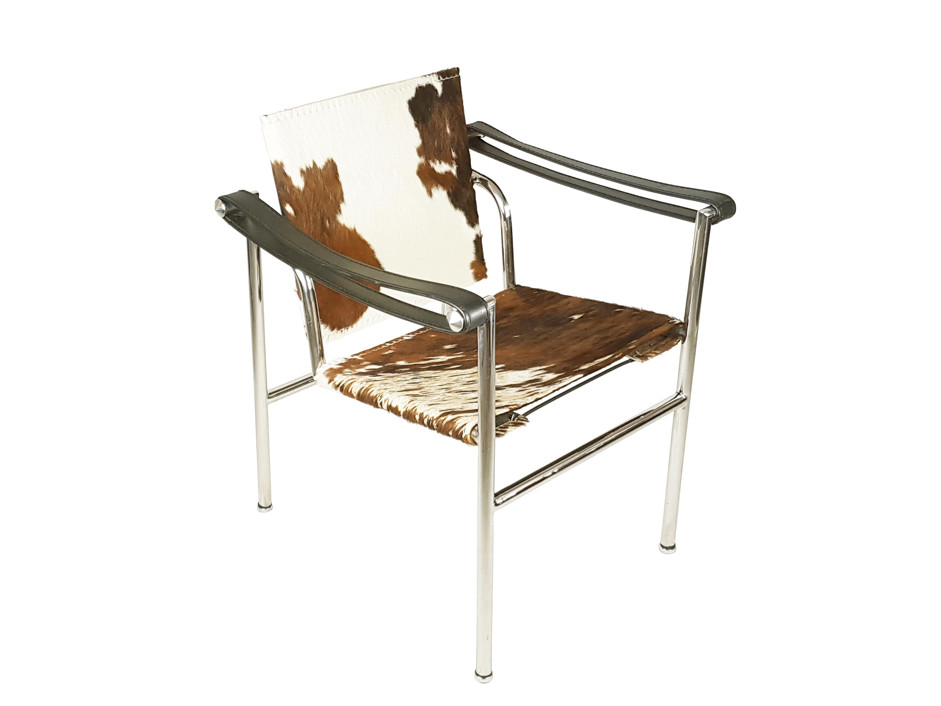 LC1 armchair designed by Le Corbusier in polished steel and chrome plated metal with seat and backrest in cow/pony leather. This armchair was produced between the '60 and the 70s. Although it does not features any signatures or serial numbers, it