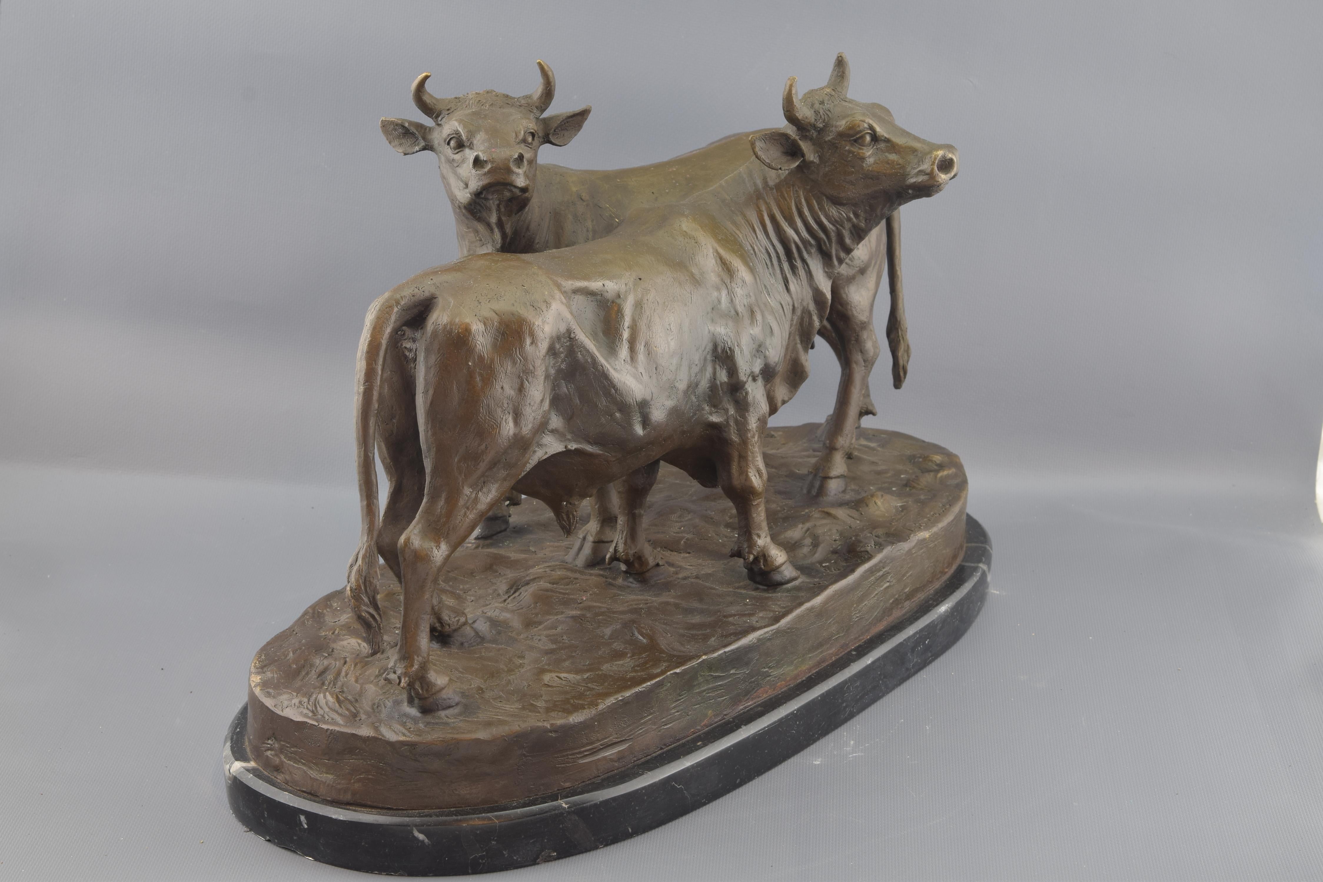 Lost wax casting. 
On an oval base in dark marble stands another, made in bronze and worked to look like a meadow. The two cattle are placed in profile, with the head of the cow higher and looking both towards the same side. The artist has been