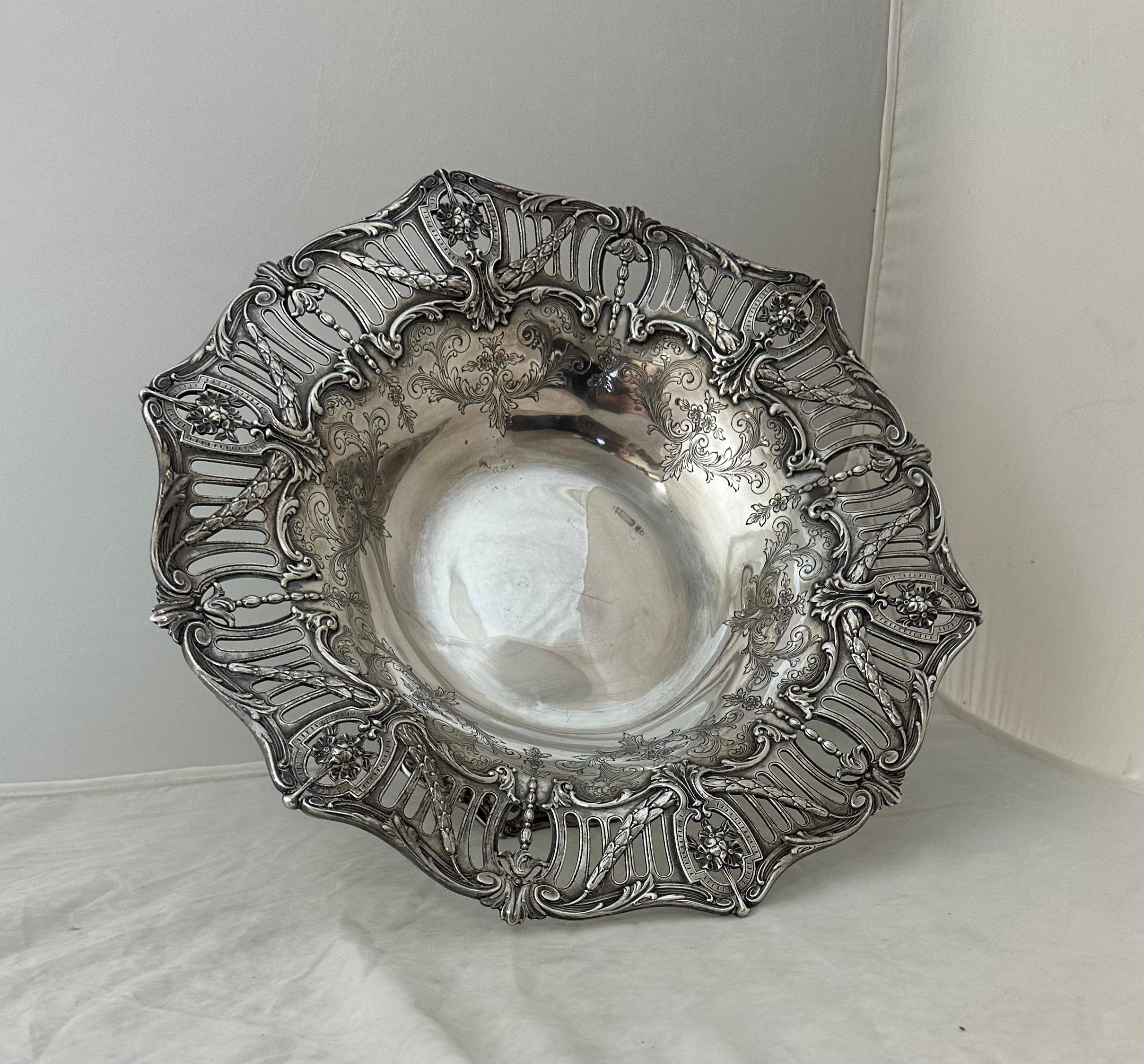 This vintage stunning sterling silver centerpiece by Cowell & Hubbard dates from the early 1900’s. It is elegantly sculpted with ornate detailed reticulated breathtaking motifs. At 38 ounces of solid silver, this dramatic oversize centerpiece will