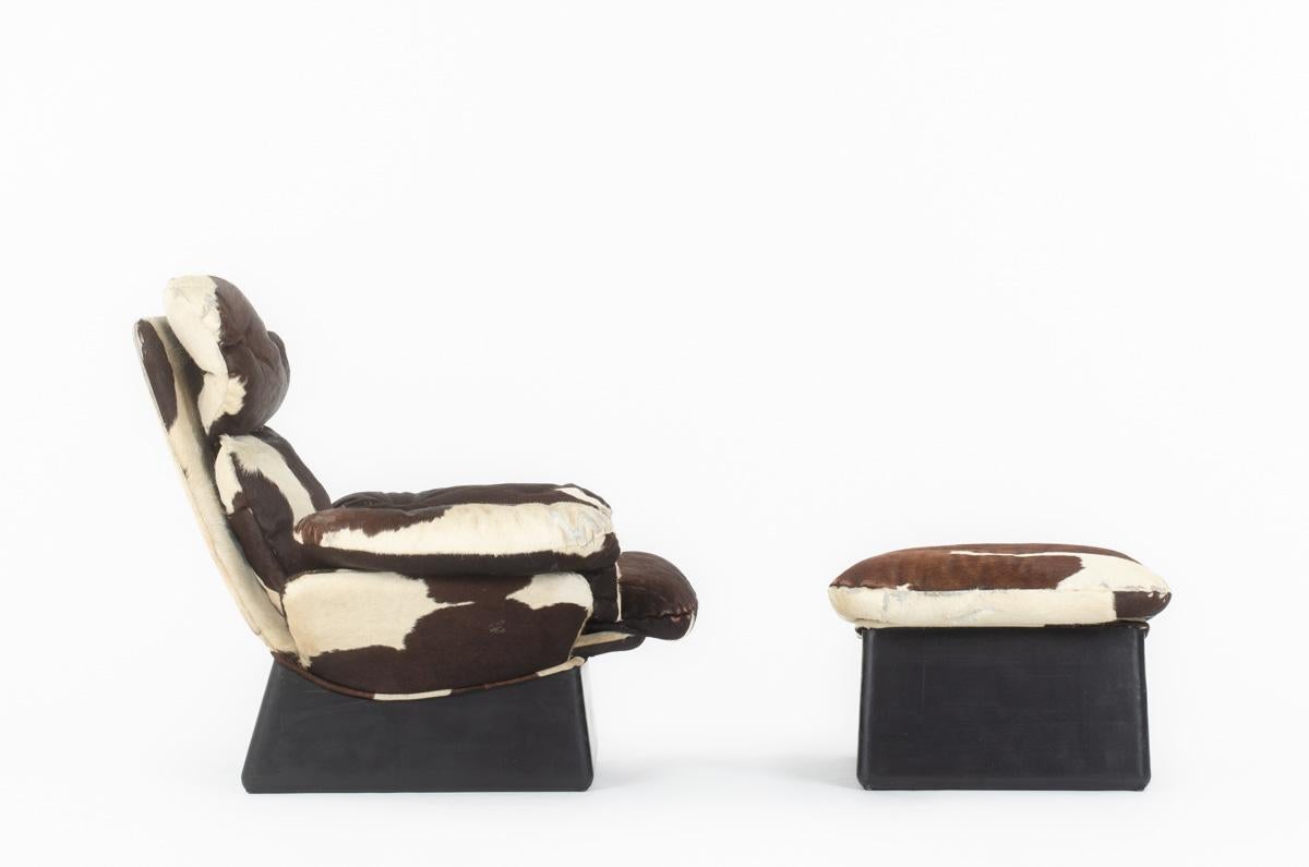French Cowhide armchair and footrest, 1970s For Sale