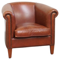 Fauteuil club en cuir de vache de couleur cognac