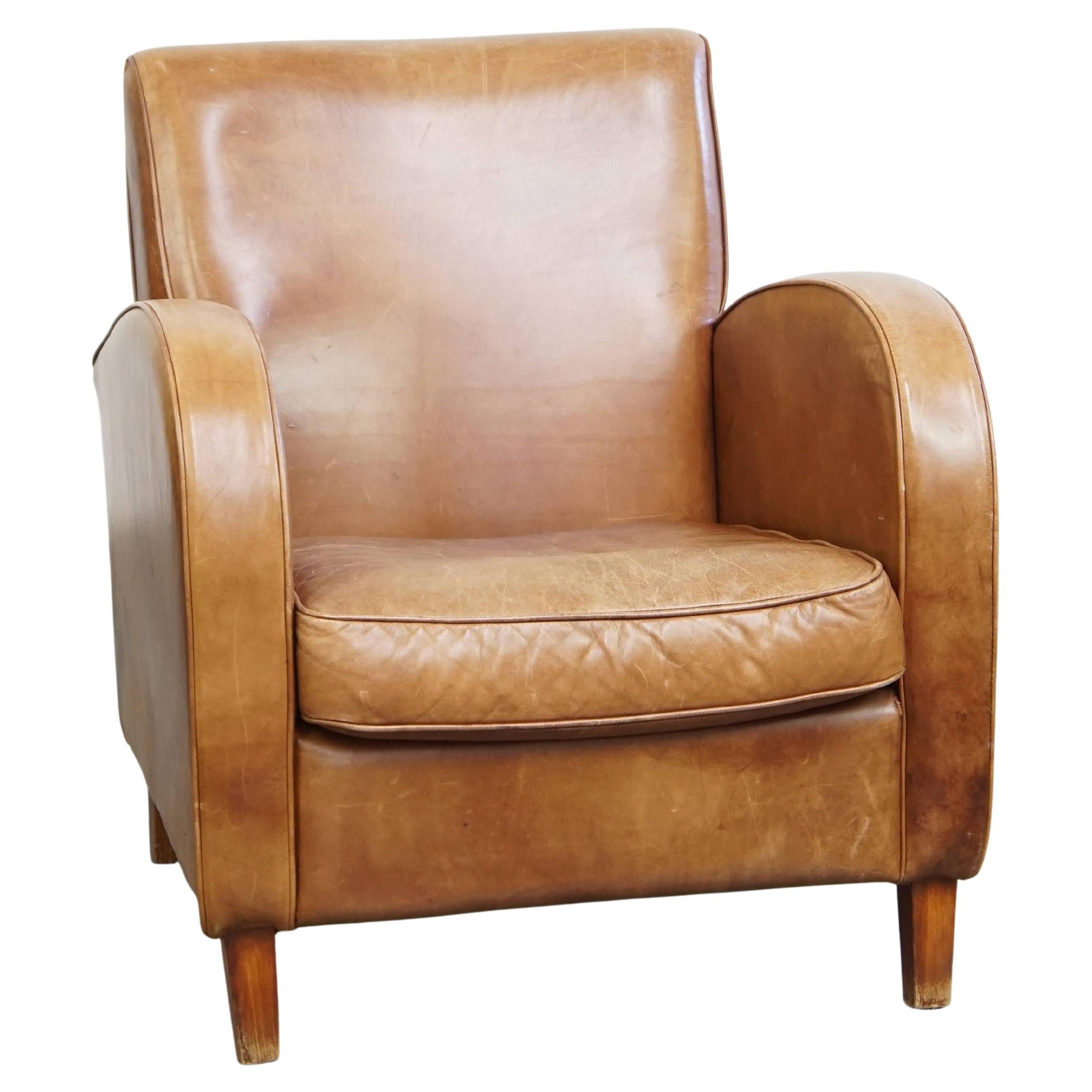 Poltrona di design in pelle di vacchetta color cognac chiaro