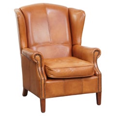 Poltrona wingback in pelle di vacchetta