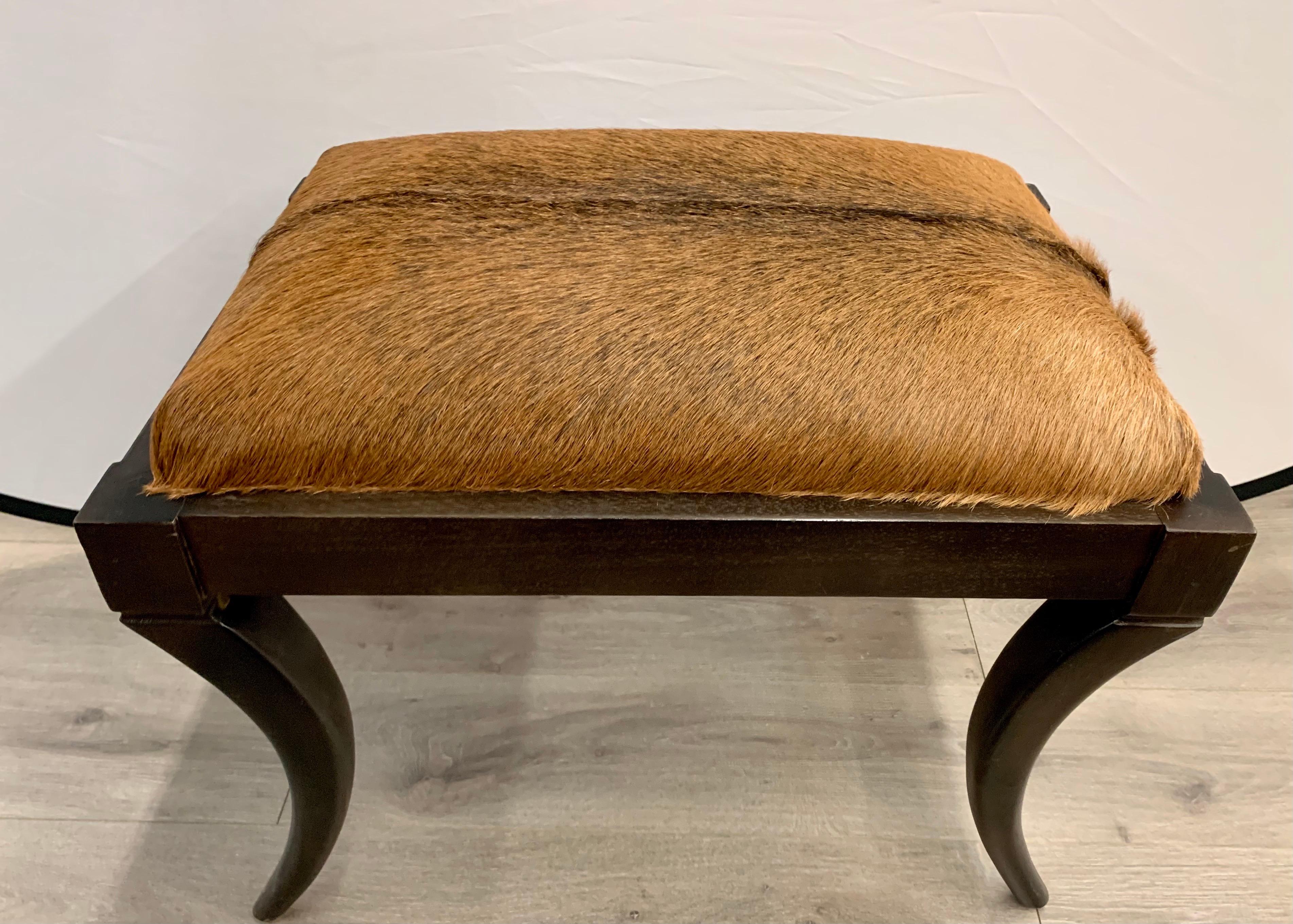 Newer upholstered cowhide adorns this bench or stool. Great scale and better lines.
  