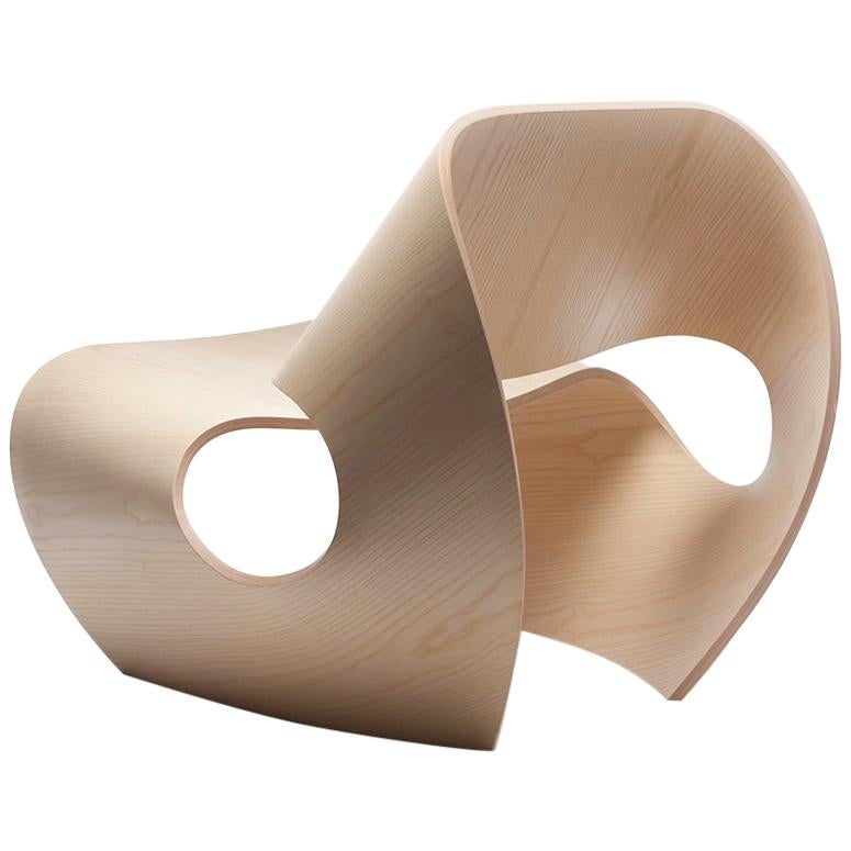 The contemporary Cowrie chair is a rock solid easy chair inspired by the concave lines of sea shells. The curvilinear forms are the result of an extensive research and innovation process that bridges the handmade with the digital. Sweeping lines are