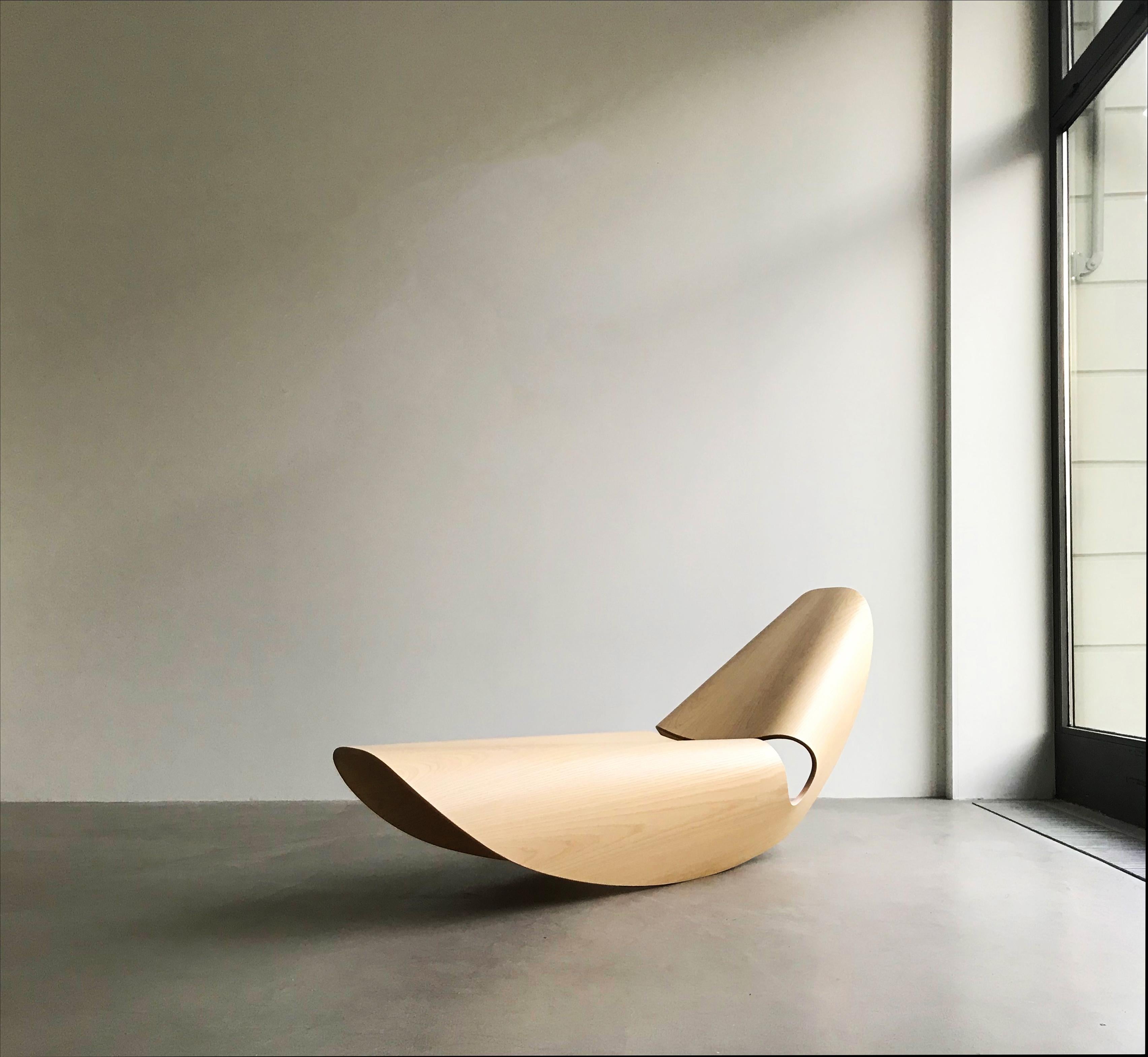 The contemporary Cowrie rocker is an elegant rocking lounger inspired by the concave lines of sea shells. The curvilinear forms are the result of an extensive research and innovation process that bridges the handmade with the digital. Sweeping lines