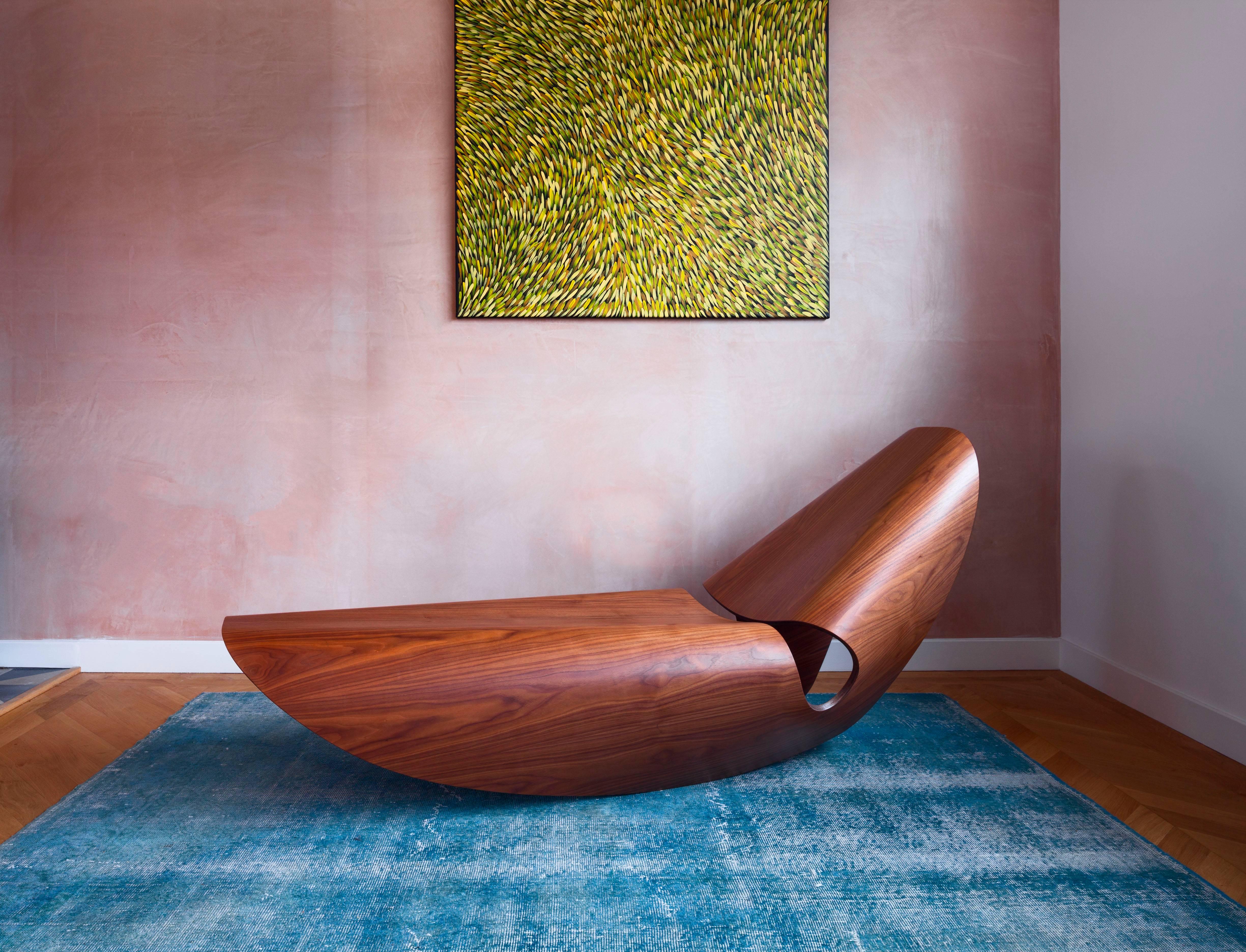 The contemporary Cowrie rocker is an elegant rocking lounger inspired by the concave lines of sea shells. The curvilinear forms are the result of an extensive research and innovation process that bridges the handmade with the digital. Sweeping lines