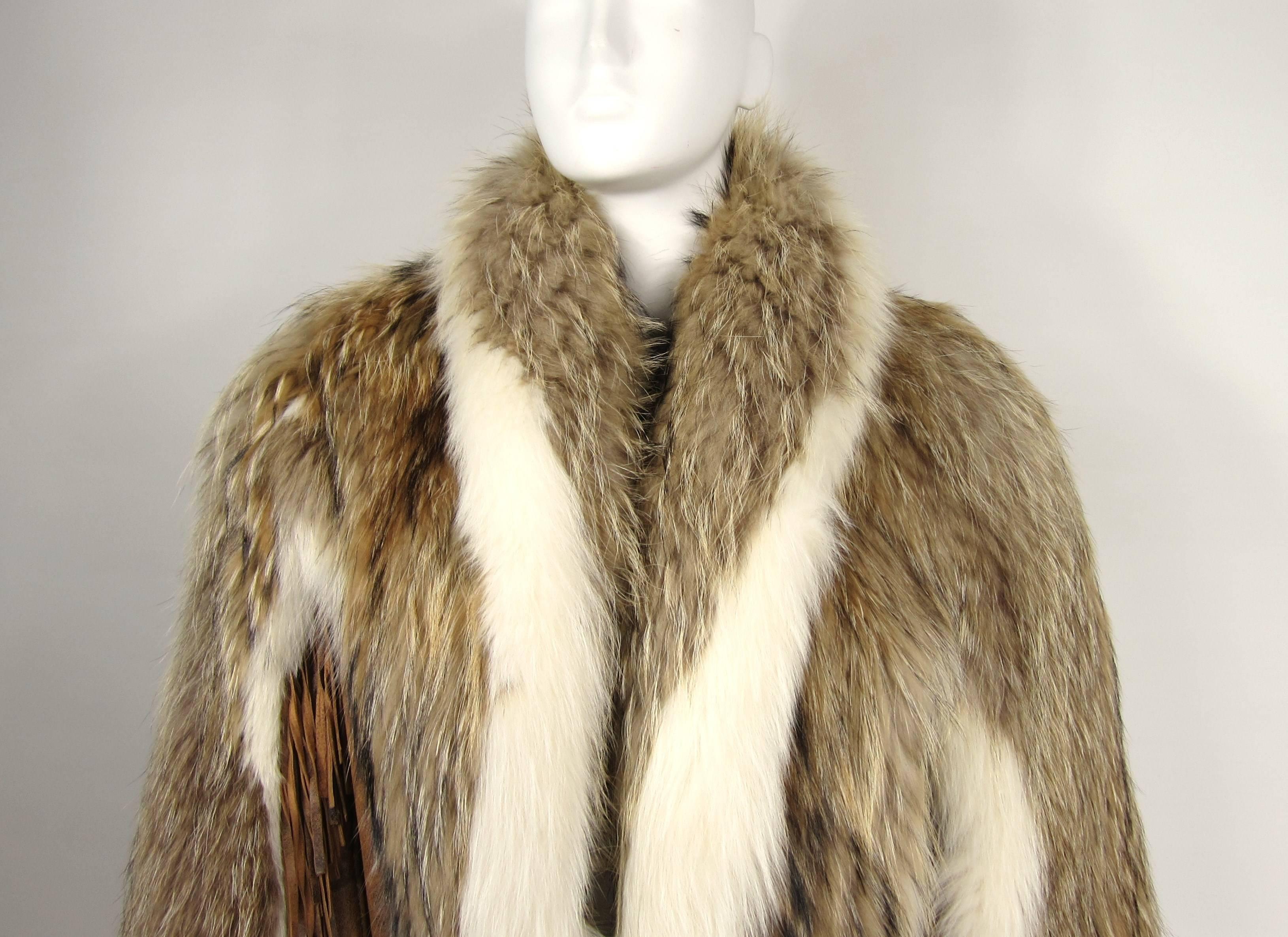 Statement piece with this 1990's Fringe Jacket. Leather jacket with accents over the shoulder of Coyote fur. Fringed on the arms and back. 2 clip closure, 2 slit pockets. Measuring approximately. Up to a 46 bust - Up to 48  waist - 40.5 length down