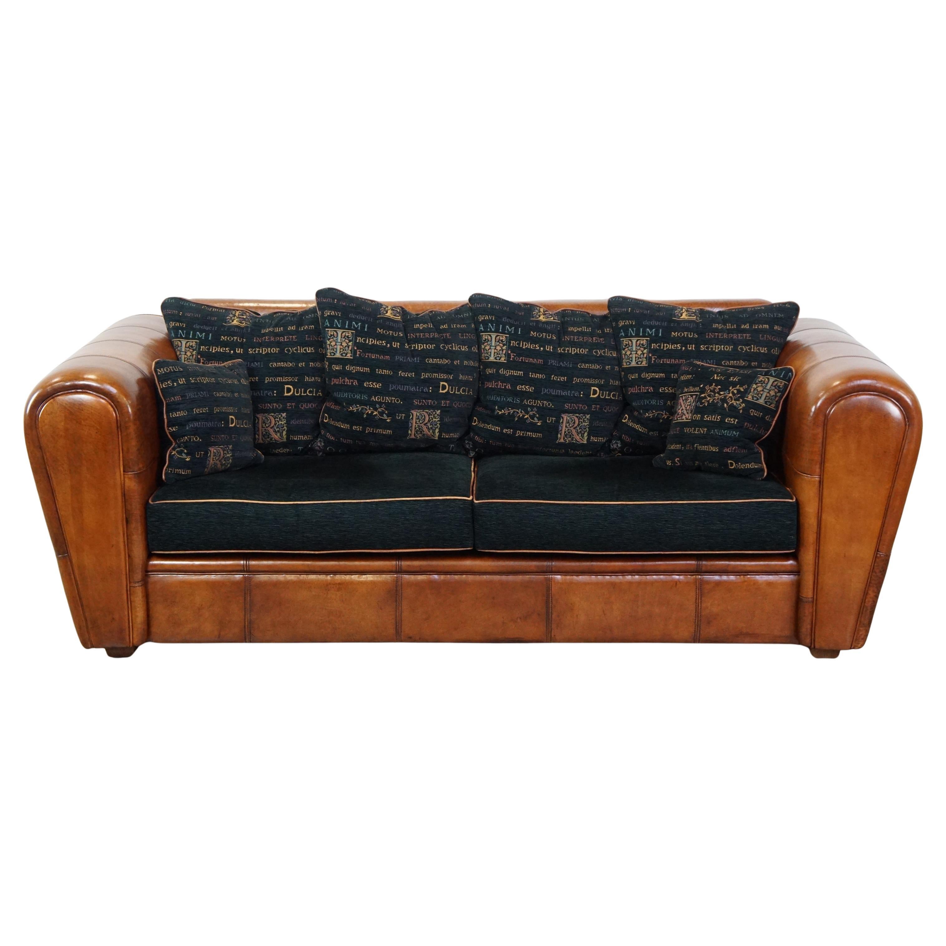 Cozy spacious 2.5-seater sheepskin leather designer sofa with fabric cushions