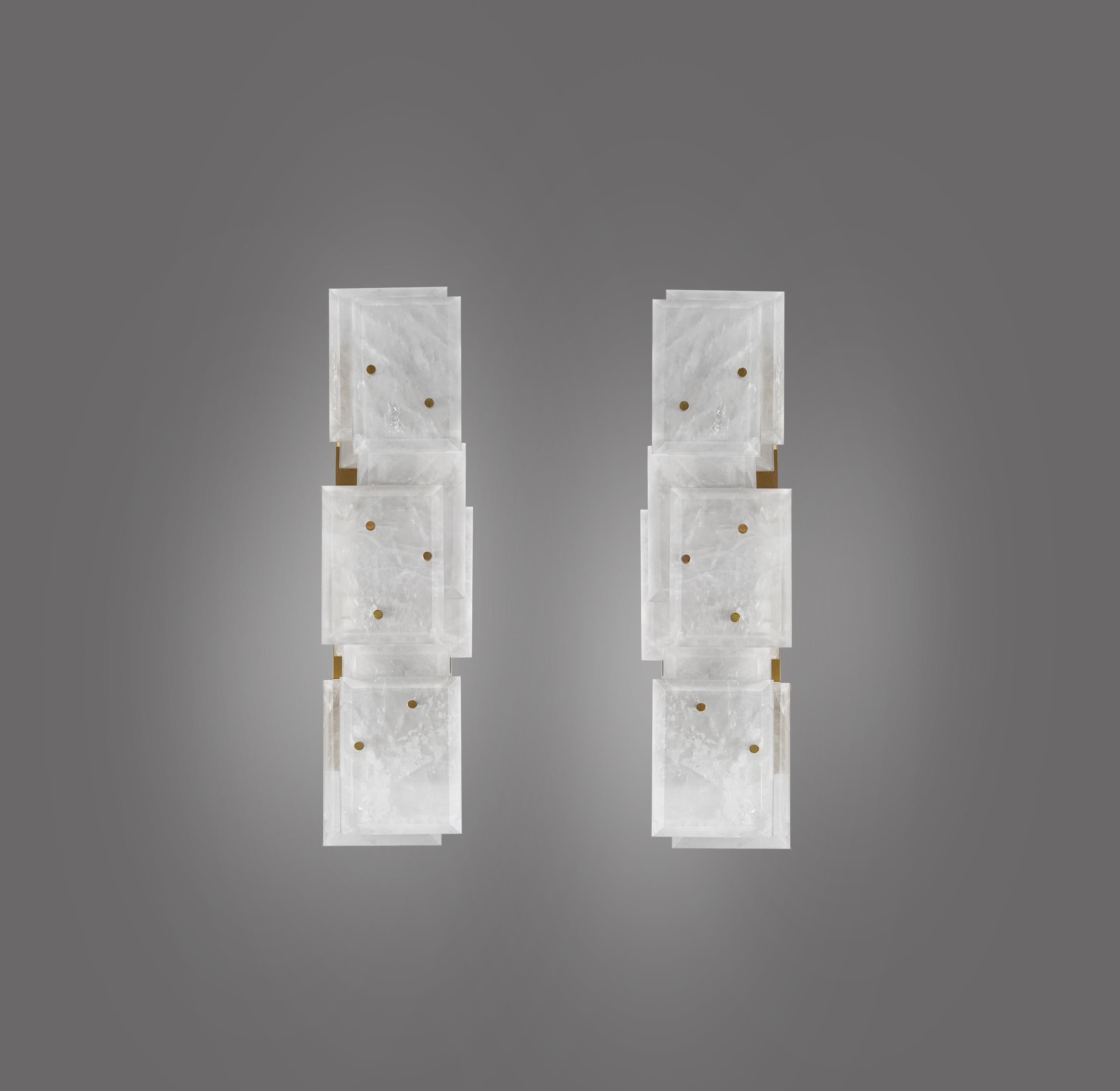 Pair of modern rock crystal quartz sconces with multiple panels decorations in polished brass finish. Created by Phoenix Gallery.
Each sconce has two sockets, use LED, long tube, warm lights.
80 watts LED, 160watts total. Warm lights are