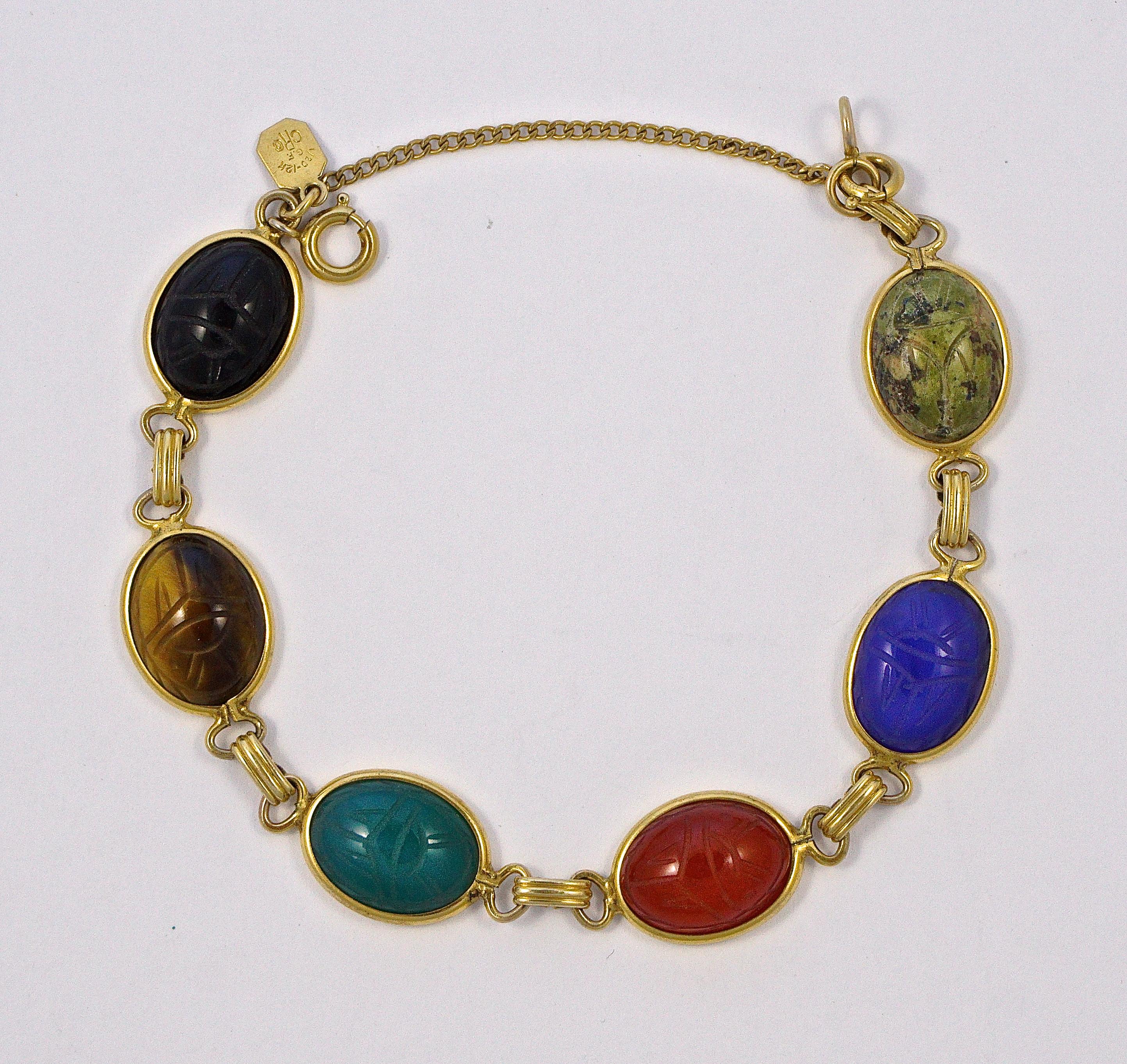 Charles Reis Company 12K gold filled vintage bracelet with a safety chain, featuring engraved scarabs on semi precious stones, including tiger eye, carnelian and black onyx. Length 19.5cm / 7.68 inches by width 1.3cm / .5 inch. The bracelet is in