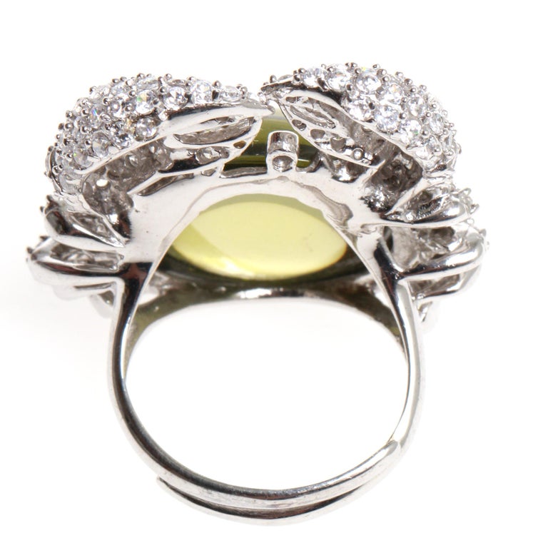 Crab ring covered in CZs and centred by one larger green glass stone