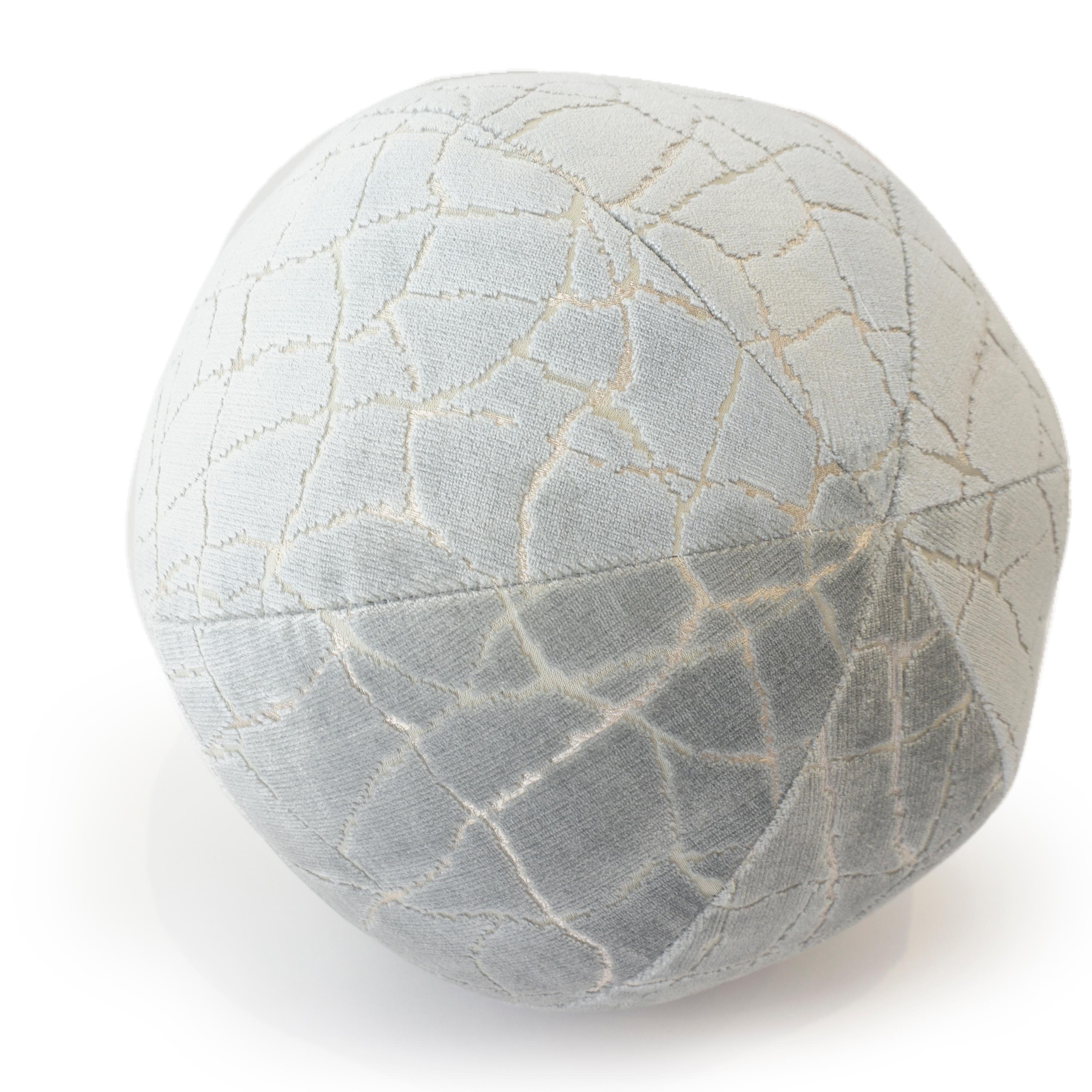 A hand sewn round ball pillow made with soft cut velvet fabric featuring a 
