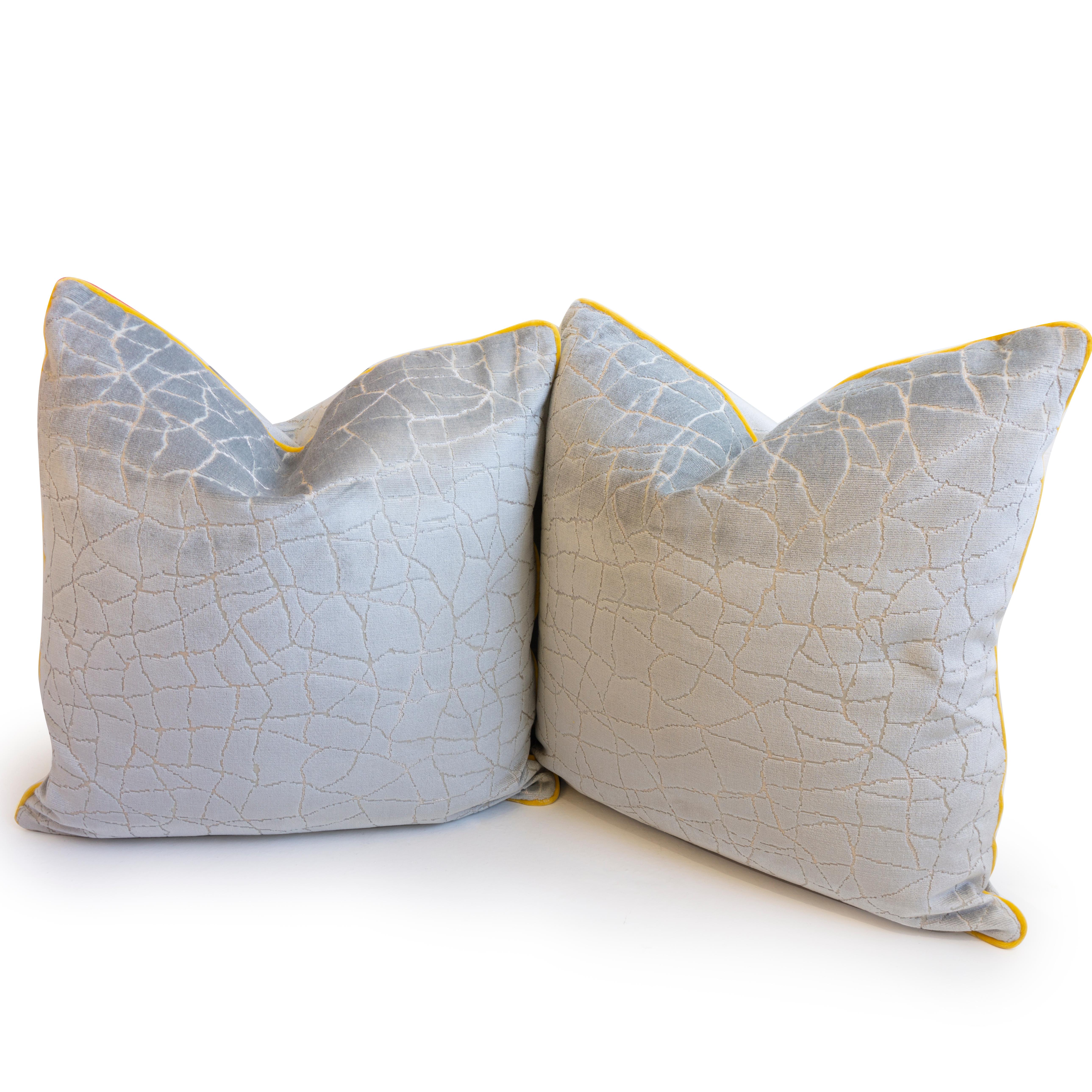 A hand sewn throw pillow made in a cut velvet fabric with 