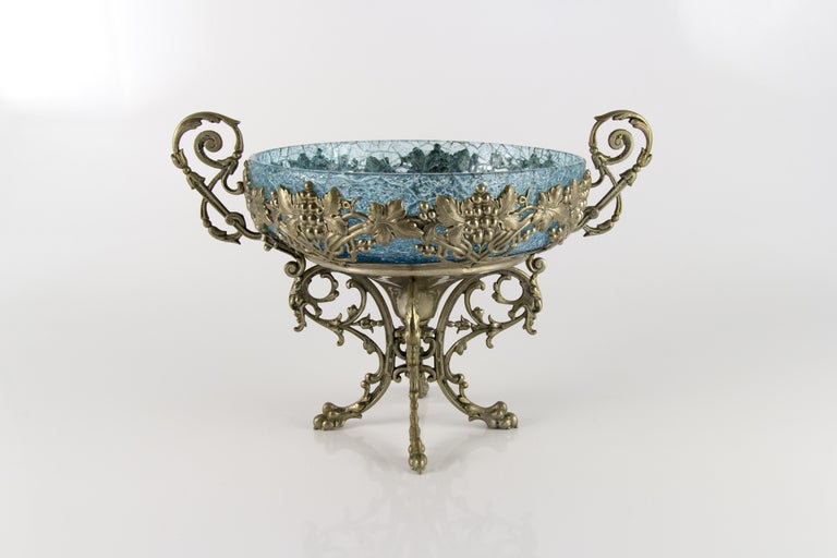 Beautiful and very decorative light blue crackle glass centerpiece bowl with ornate stand on four paw feet, decorated with grapes and grape leaves. France, 1930s.
Dimensions:
Height 20 cm / 7.87 in, width 28 cm / 11.02 in, depth 20 cm / 7.87