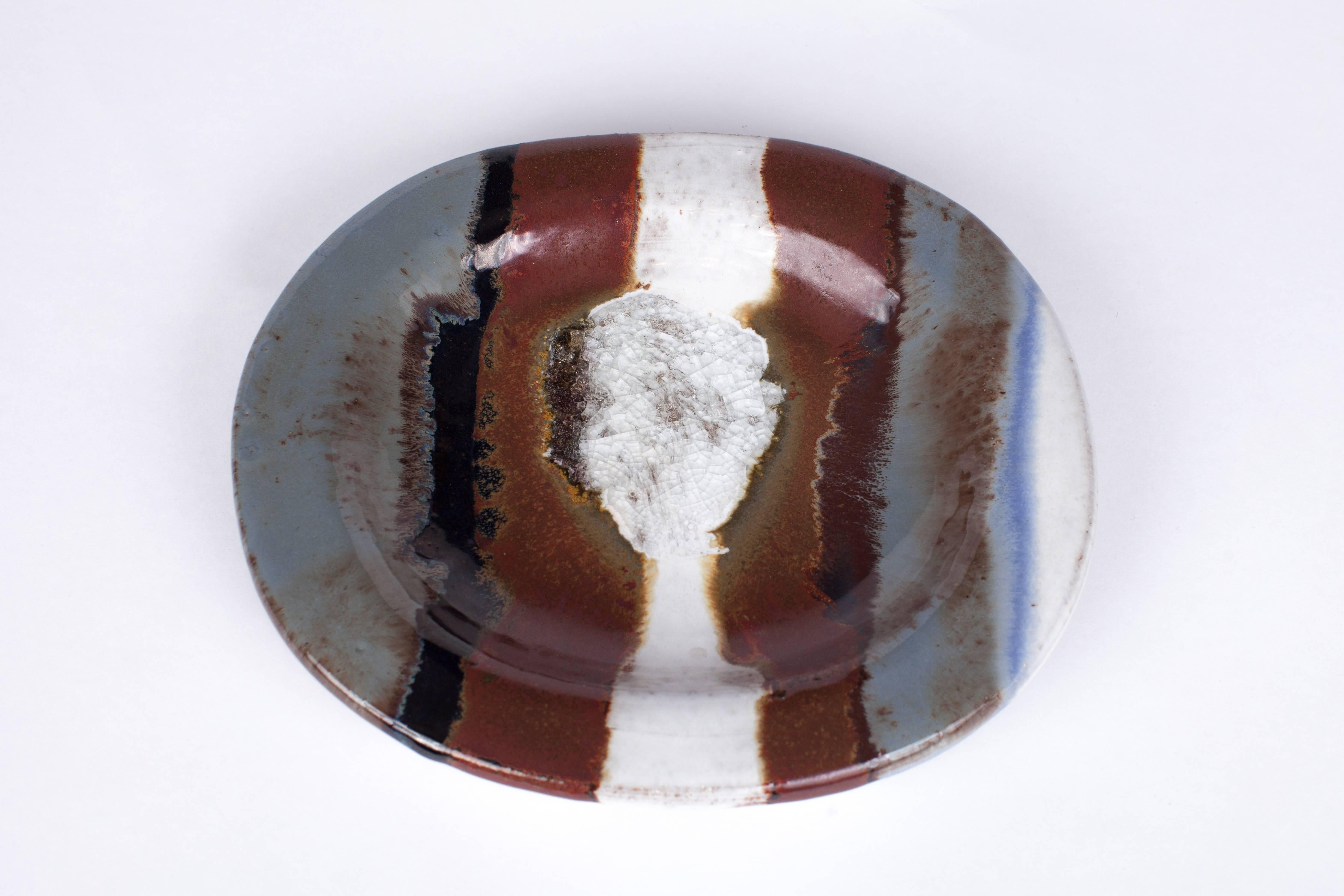 Jacques Pouchain (1925-2015)

Glazed ceramic dish by French ceramicist and painter Jacques Pouchain, with vigorous, expressionist swaths of slate, rust, black, blue, brown, and white finished with metal oxide and crackle glaze.

Signed.

12’’ L x