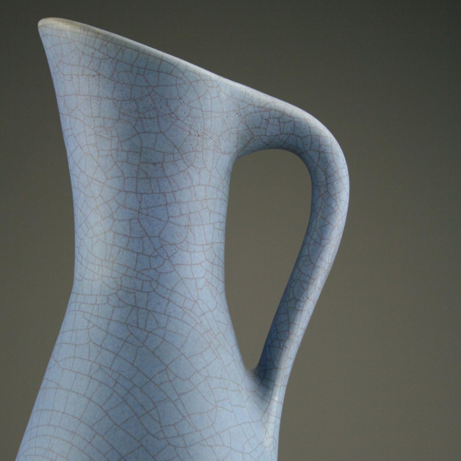A large pitcher in pale blue matte crackle-effect glaze by German ceramicist Ernst Lösche (1923-2010).

Ernst Lösche trained with Gustav Frosch between 1945 and 1947 and studied under Academy Professor Karl Lösche, his father. He founded his own