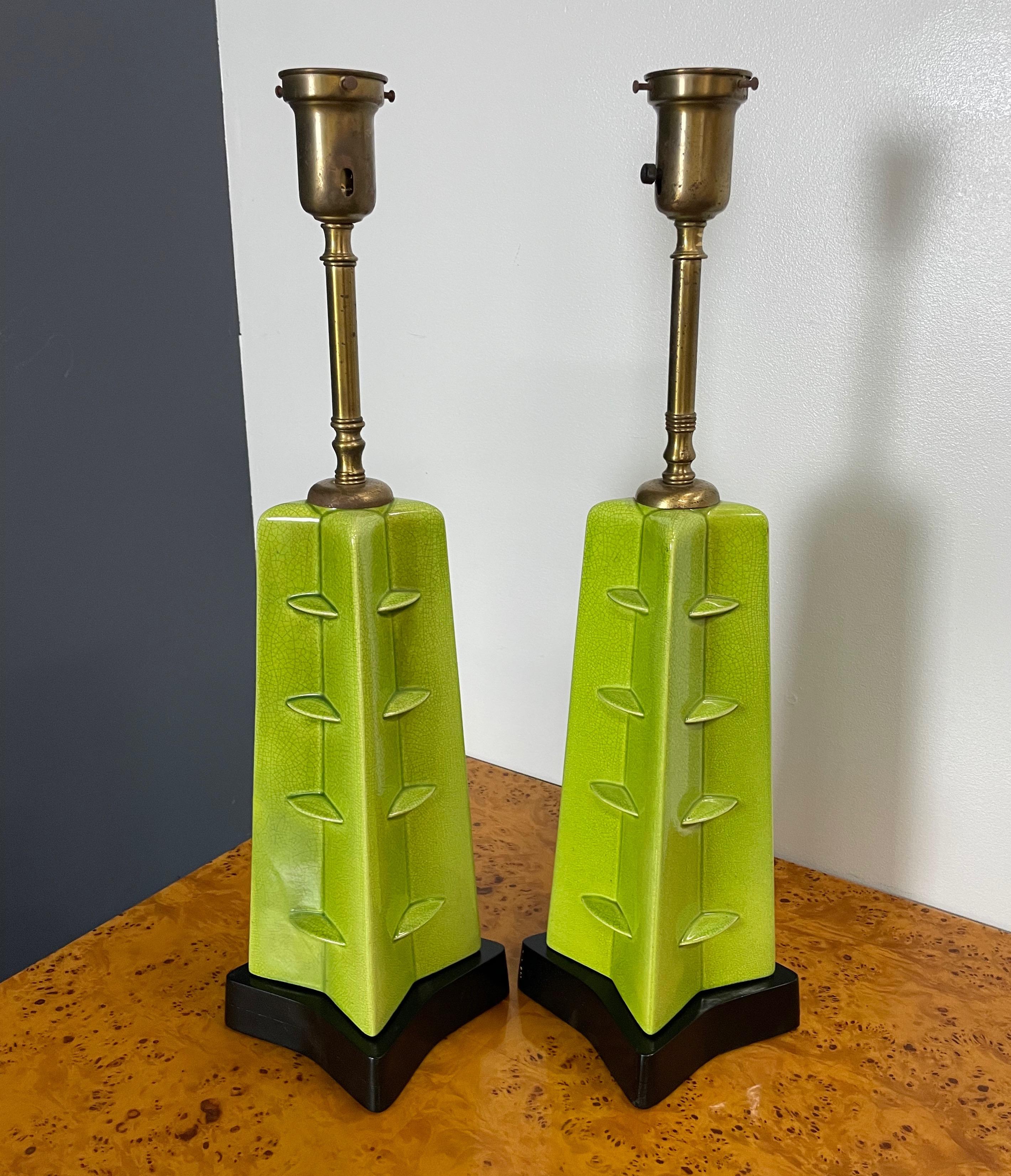 These wonderful ceramic lamps are a towering presence with their unusual chartreuse crackle glaze and their wooden base that mirrors the shape of the ceramic.