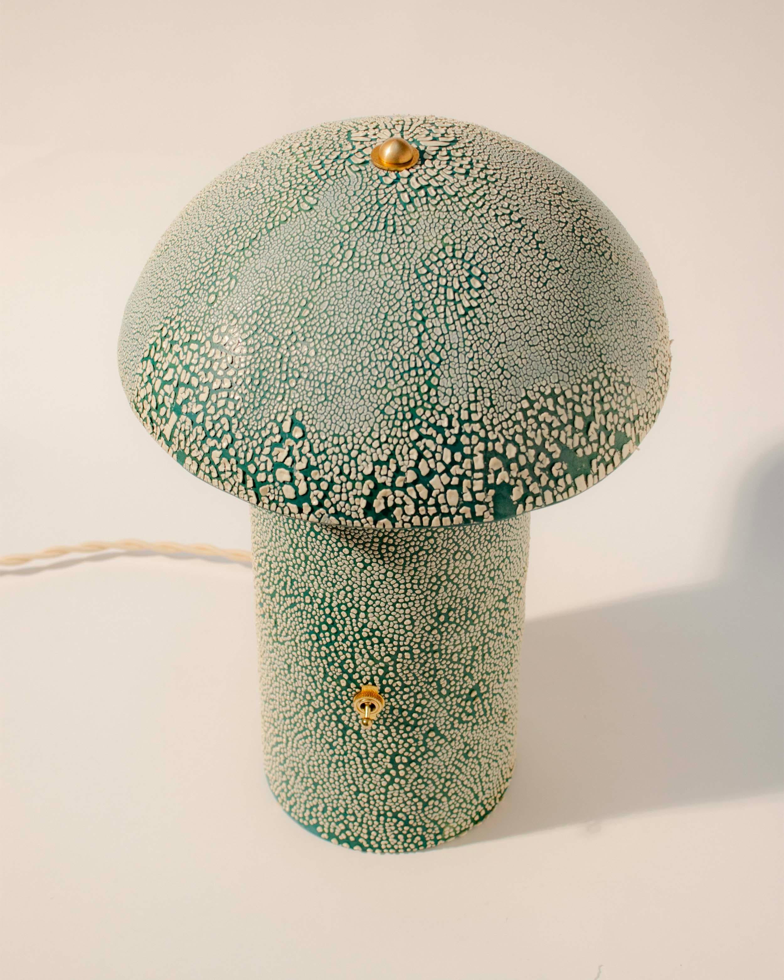 Every mushroom lamp is hand-made and hand-painted by Ethan Streicher, the founder and designer behind the Streicher Goods brand in Brooklyn, NY. The lamp's silhouette is simple and contemporary, featuring a tall cylindrical base that seamlessly