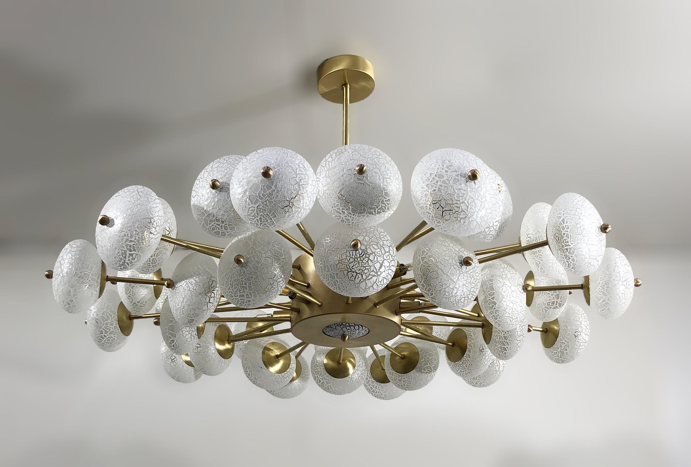 Limited edition Italian chandelier with crackled frosted white Murano glass orbs, mounted on satin brass finish frame / Designed by Fabio Bergomi for Fabio Ltd / Made in Italy
12 lights / G9 type / max 40W each
Measures: diameter 49 inches, height