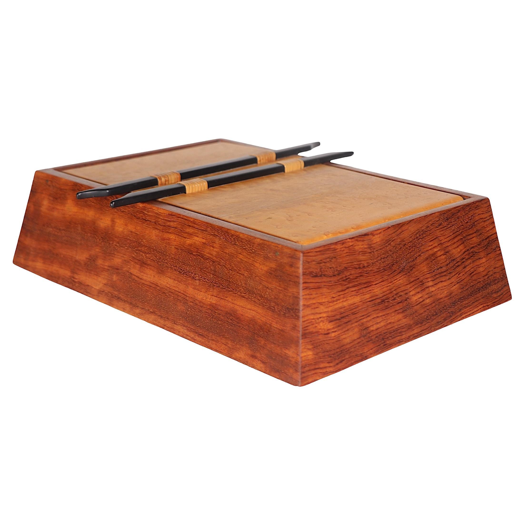 Exceptional hand made wood jewelry box by noted California artist Larry Dern, circa 1980's. The box features two burl swing open doors at the top which open to reveal a sliding jewelry and removable tray, with a suede lined bottom. The case has