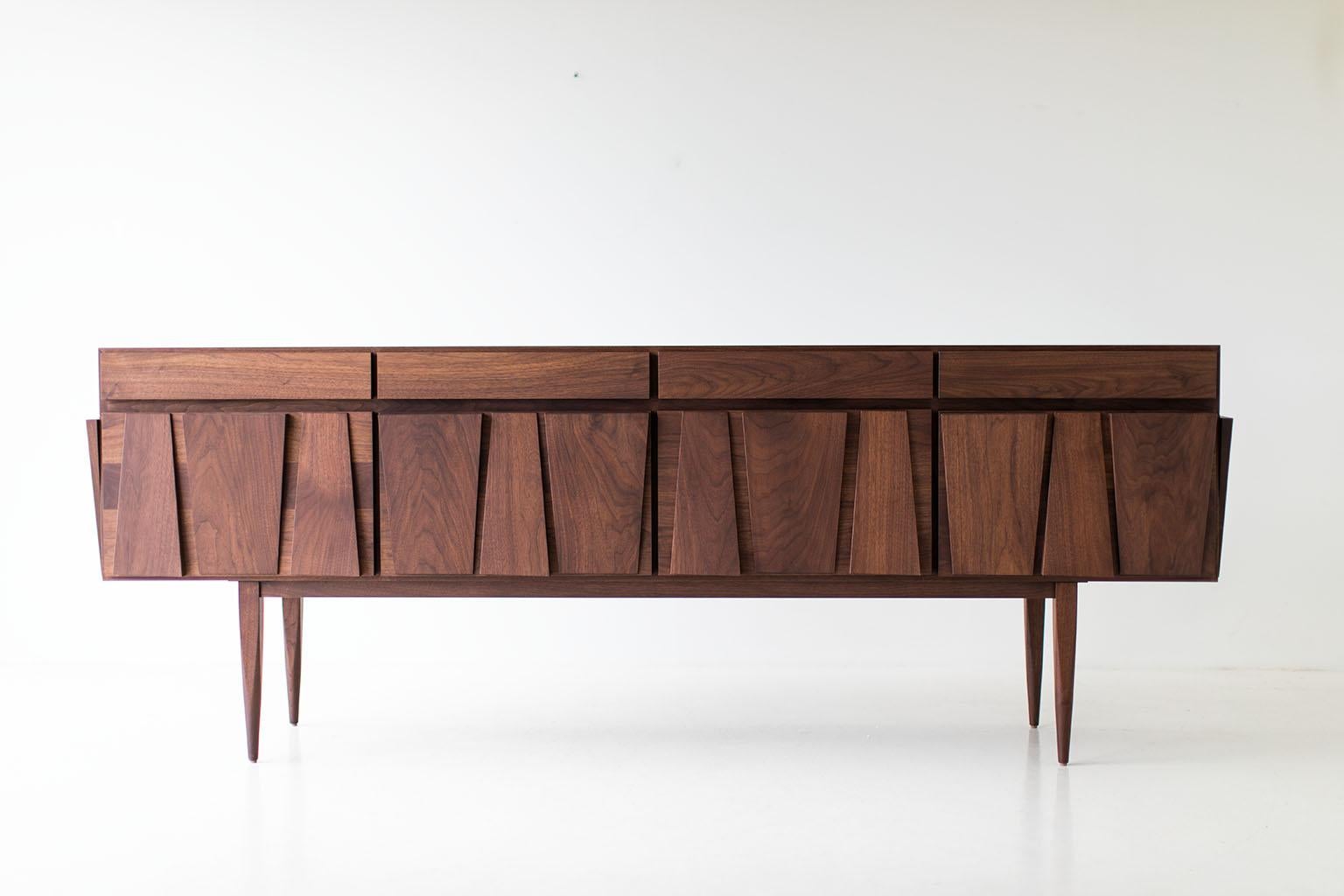 CraftAssociates Sideboard, Eiger Modern Walnut Sideboard

Modern Credenza - Craft Associates® Furniture is expertly crafted. The base is constructed by hand from hard wood and not machine. The walnut is then shaped by artisans and finished with a