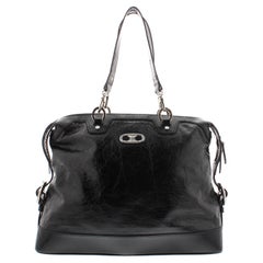 Crafted out of black distressed patent leather, silver-tone hardware