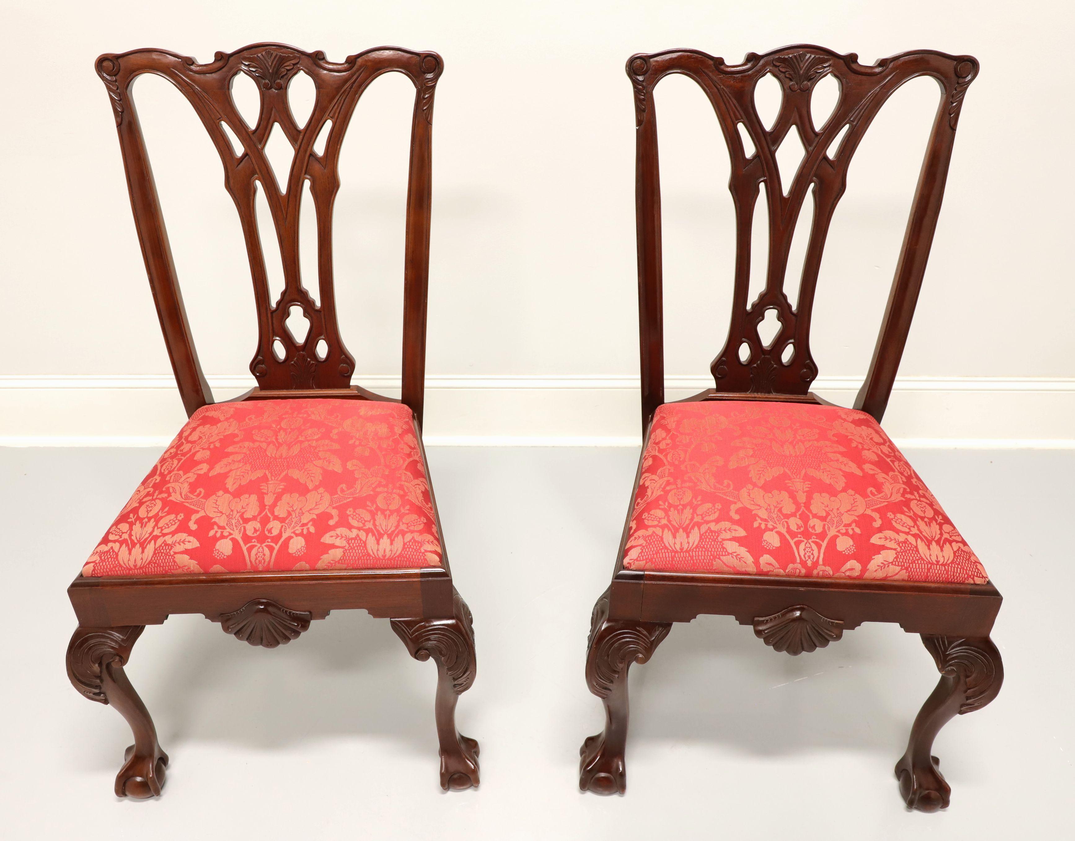 A pair of Chippendale style dining side chairs by high-quality furniture maker Craftique. Solid mahogany with their Mellowax finish, carved crest rail, carved back, red & gold colored brocade like fabric upholstered seat, carved shell to front