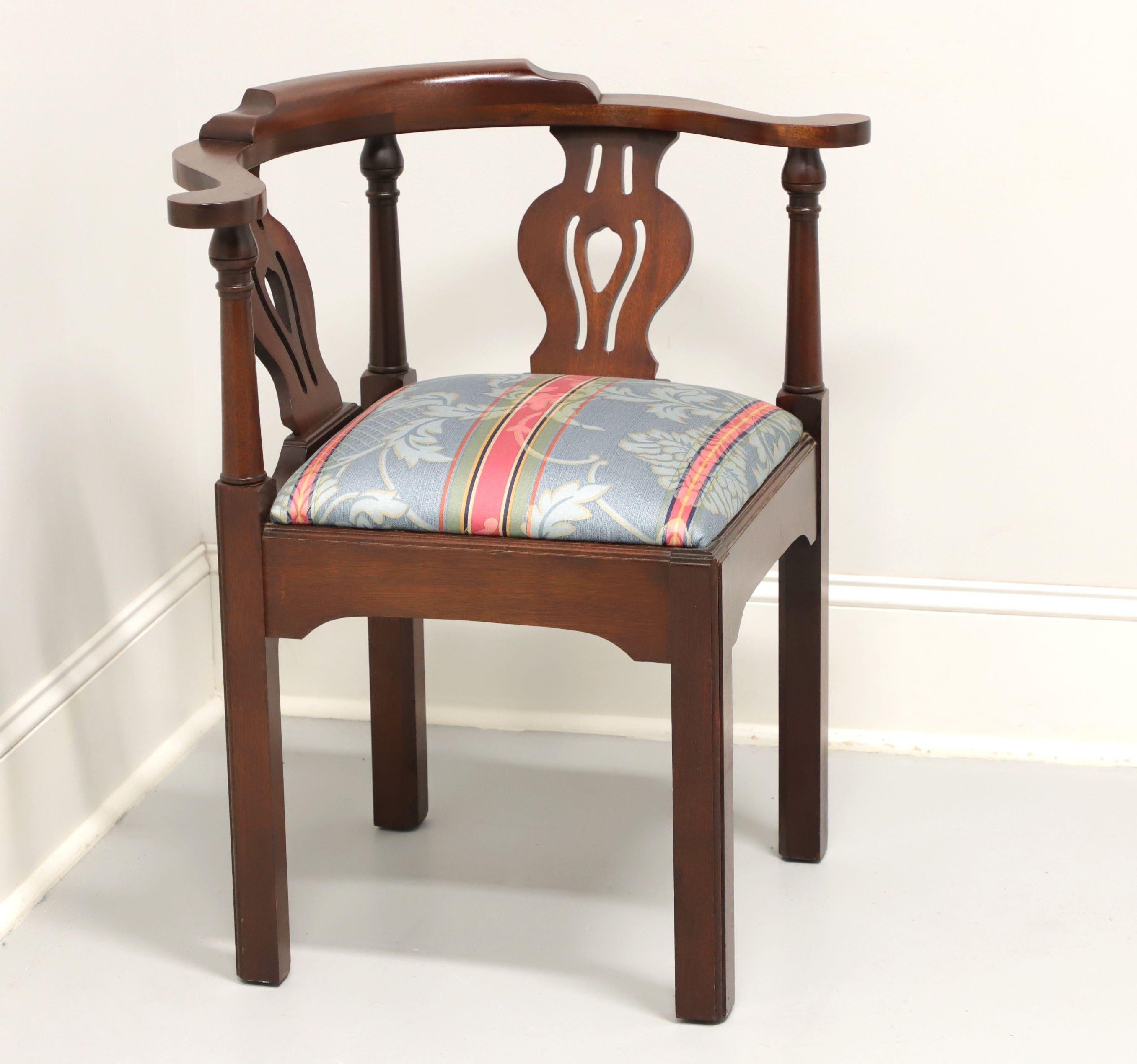 A Chippendale style corner chair by high-quality furniture maker Craftique. Solid mahogany with their Old Wood finish, curved crestrail, carved backrest, blue/silver/pink/green color stripe fabric upholstered seat, carved apron and straight legs.