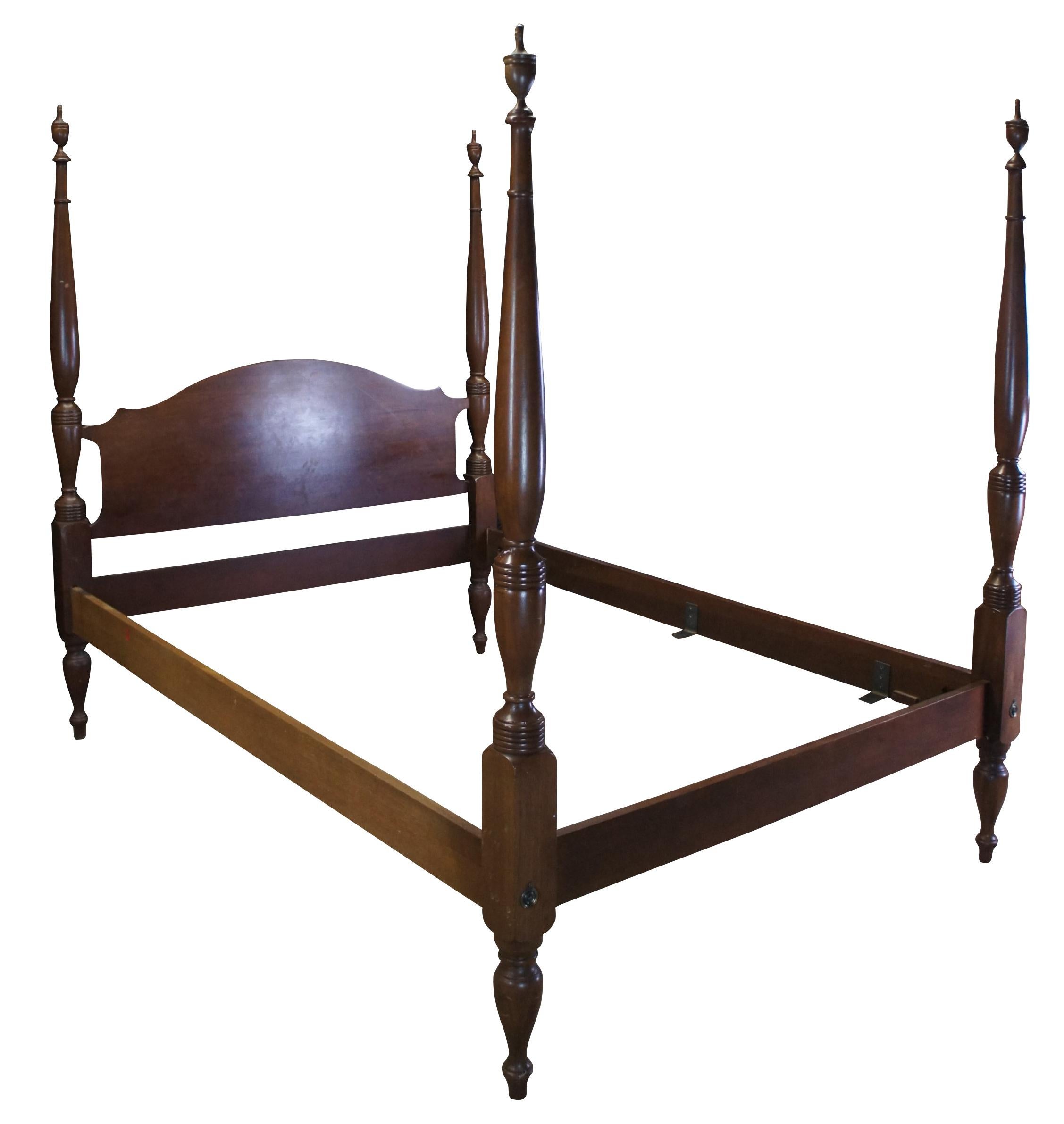 A beautiful 4 poster solid Mahogany Bed by Craftique. Craftique was founded in 1946 by L.P. Best, who sold the company to Pulaski Furniture in 1988. This bed features a camelback headboard and long turned ribbed posts with carved accents leading to