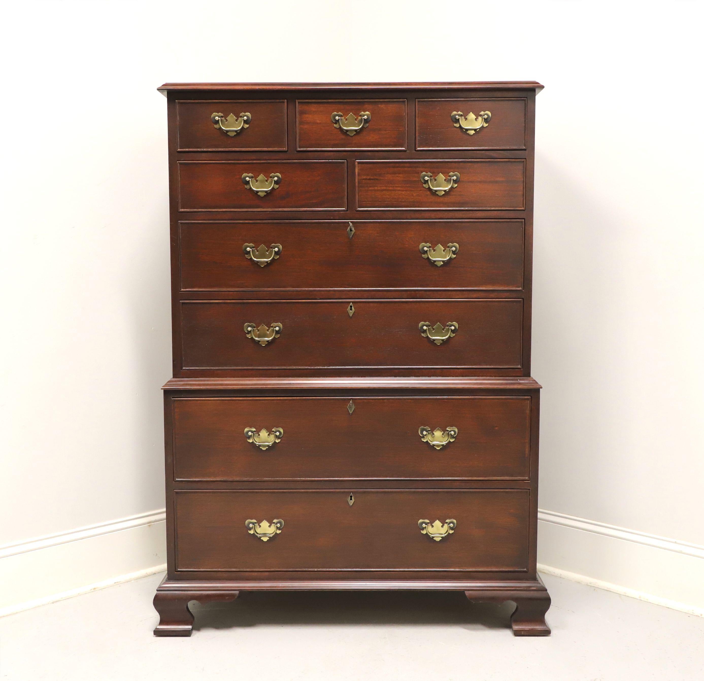 A Chippendale style chest on chest by high-quality furniture maker Craftique. Solid mahogany with brass hardware, brass keyhole escutcheons and ogee bracket feet. Features nine various size drawers of dovetail construction, four larger being