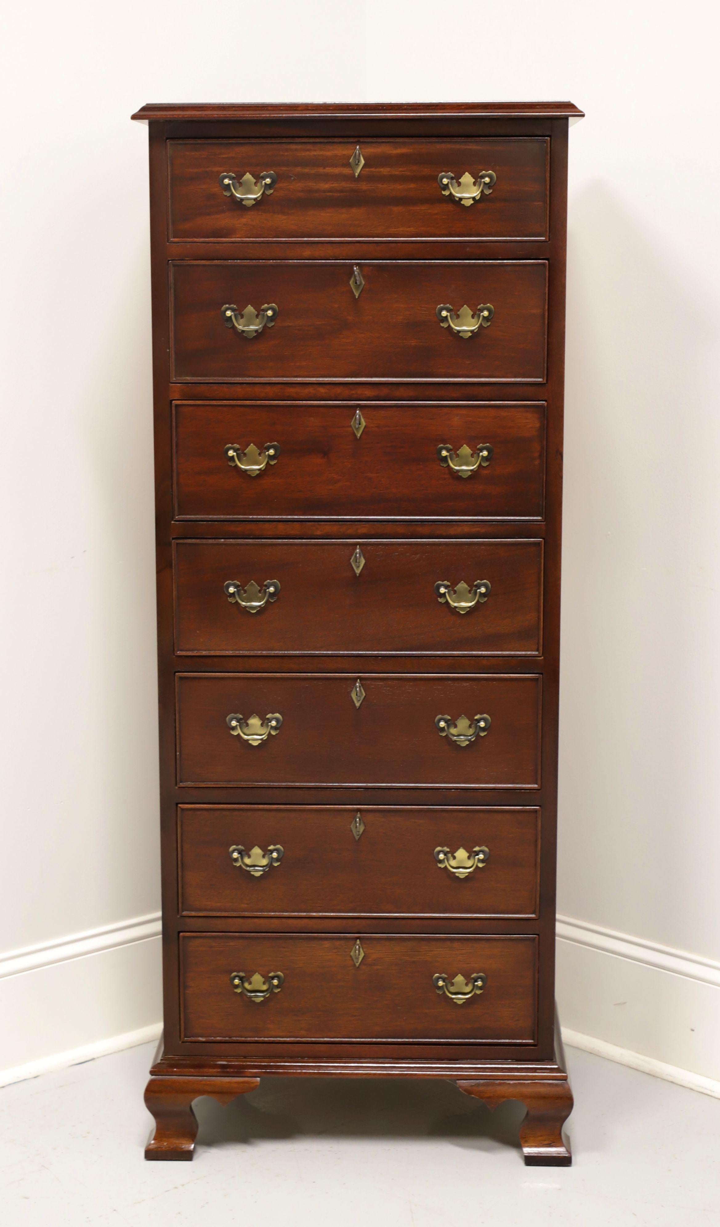 A Chippendale style lingerie chest by top-quality furniture maker Craftique. Solid mahogany with brass hardware and ogee bracket feet. Features seven drawers of dovetail construction, all of which are lockable. Includes seven keys. Made in Mebane,