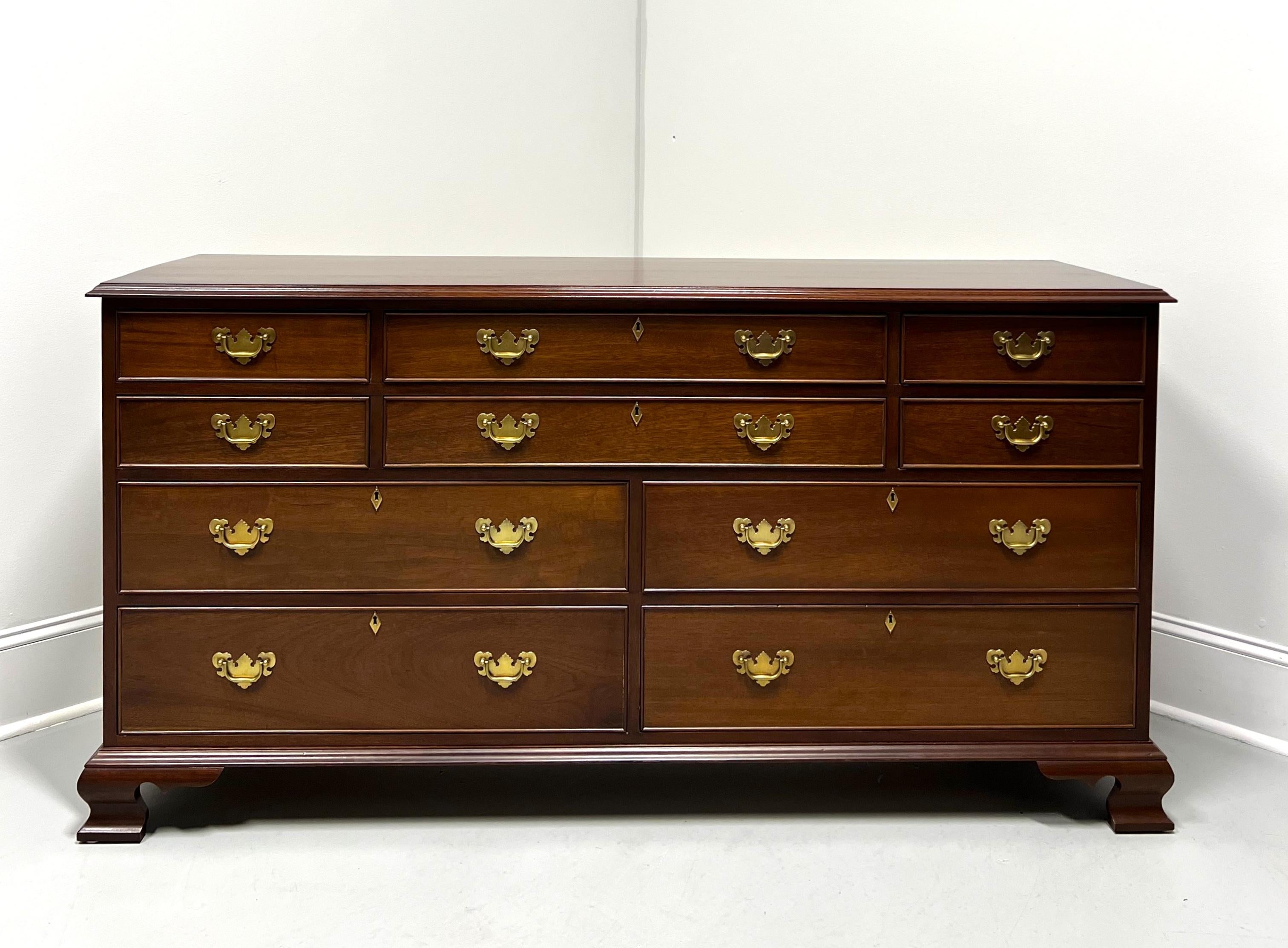 A Chippendale style triple dresser by high-quality furniture maker Craftique. Solid mahogany with their Old Wood finish, brass hardware, ogee edge to the top, brass keyhole escutcheons, and ogee bracket feet. Features ten various size drawers of