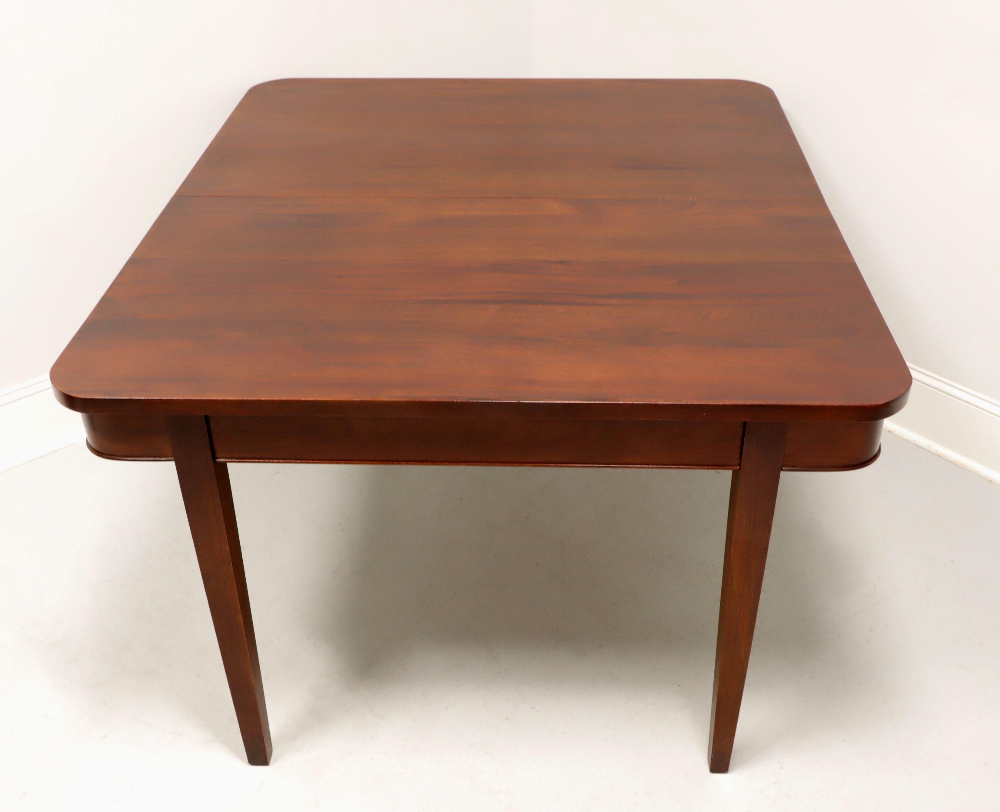An adapted Colonial style dining table by high-quality furniture maker Craftique. Solid mahogany with their Old Wood finish, rounded corners & smooth edge to the top, rounded apron with bevel edge, and four inset from corner edge tapered straight