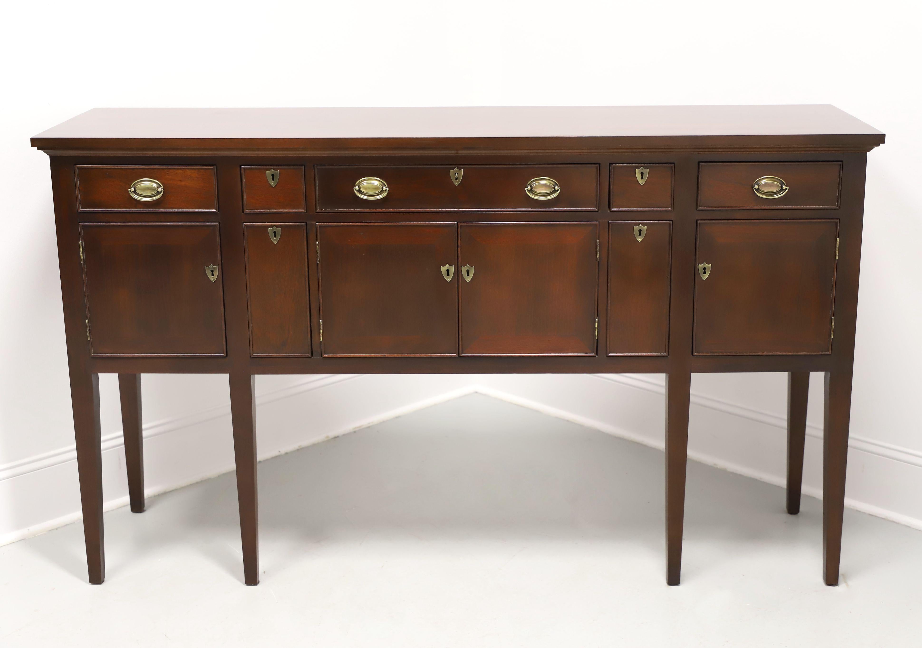A Georgian style huntboard by high-quality furniture maker Craftique. Solid mahogany with their Mellowax finish, brass hardware, squared miter edge to top, banded door fronts, and tapered straight legs. Features five felt lined drawers over a two