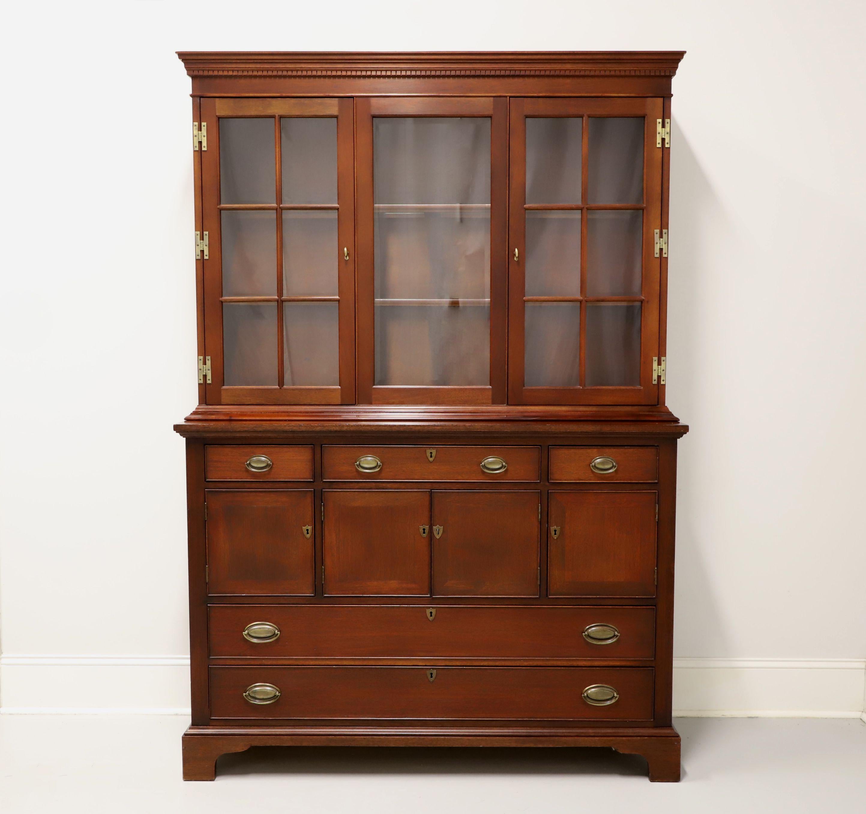 A Georgian style china cabinet hutch by high-quality furniture maker Craftique. Solid mahogany with their English Mahogany finish, brass hardware, crown molding, and bracket feet. Upper cabinet features two fixed plate-grooved wood shelves with four