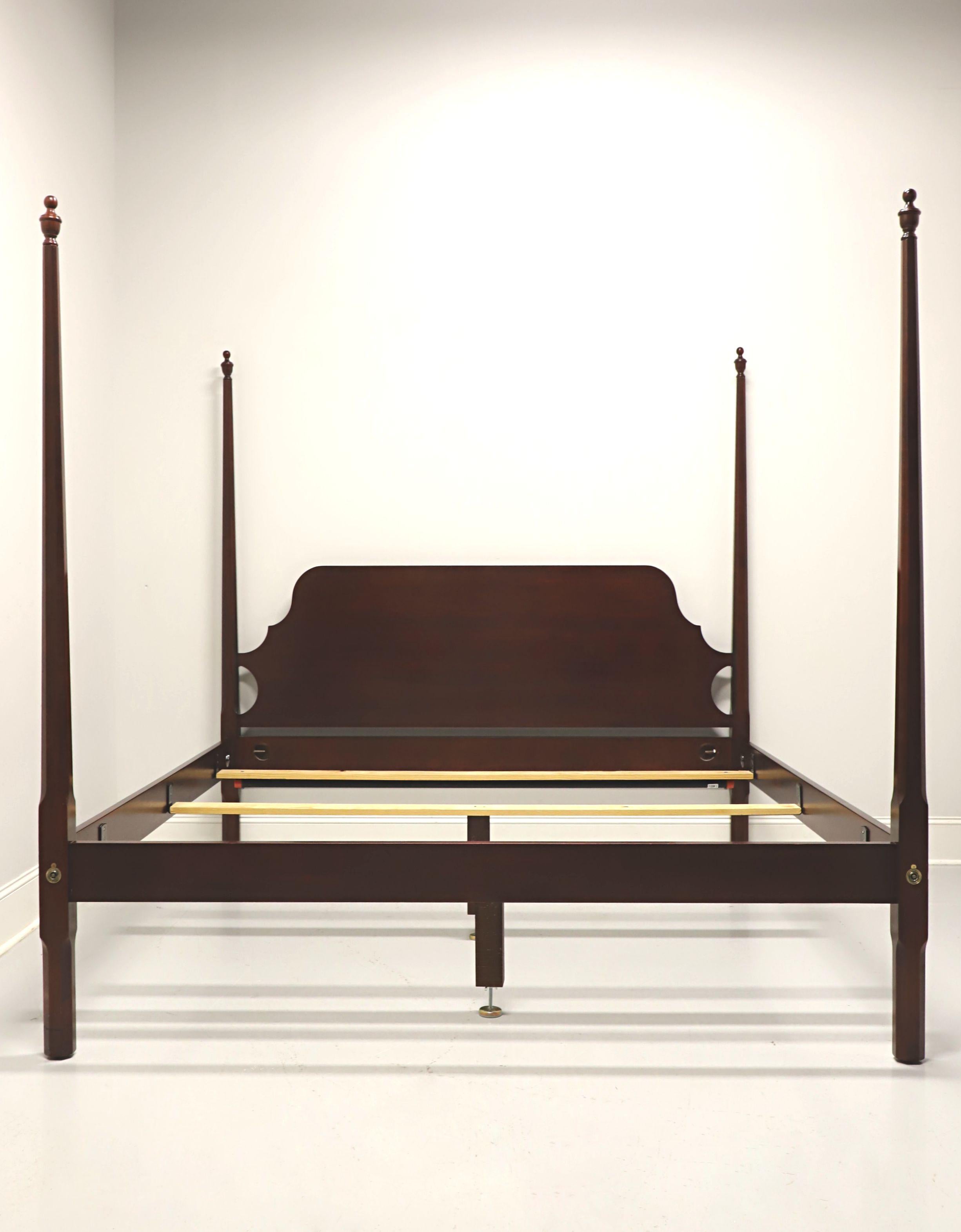 A Traditional style king size pencil post bed by Craftique. Solid mahogany with four pencil shaped posts with finials, brass covers to headboard & footboard, mounted to posts side rails, and metal side rail bracers with three wood slats, two with