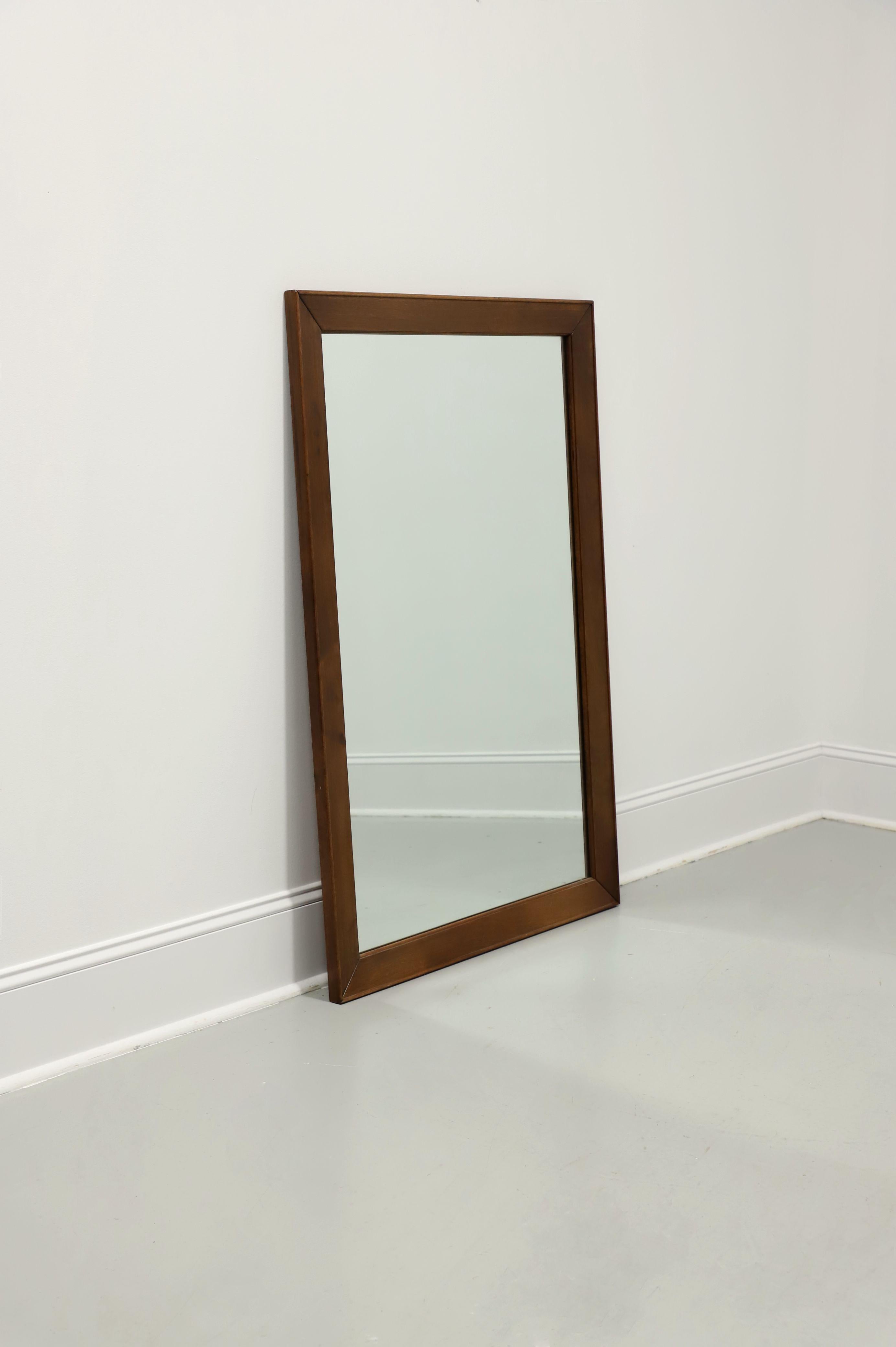 A Traditional style rectangular dresser or wall mirror by high-quality furniture maker Craftique. Mirrored glass in a solid mahogany frame with a smooth edge and their Old Wood finish. Hanging brackets are portrait oriented, but could be easily