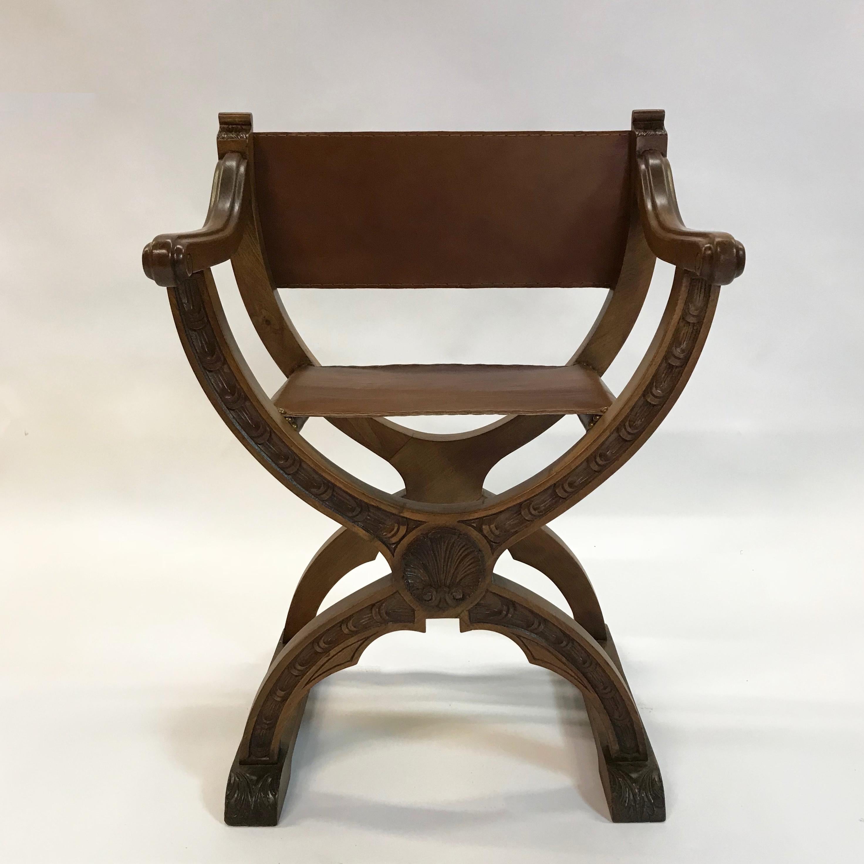 Mid-20th century, craftsman, Campaign or prayer chair features a carved cherry frame with newly upholstered luggage tan leather seat and back.
